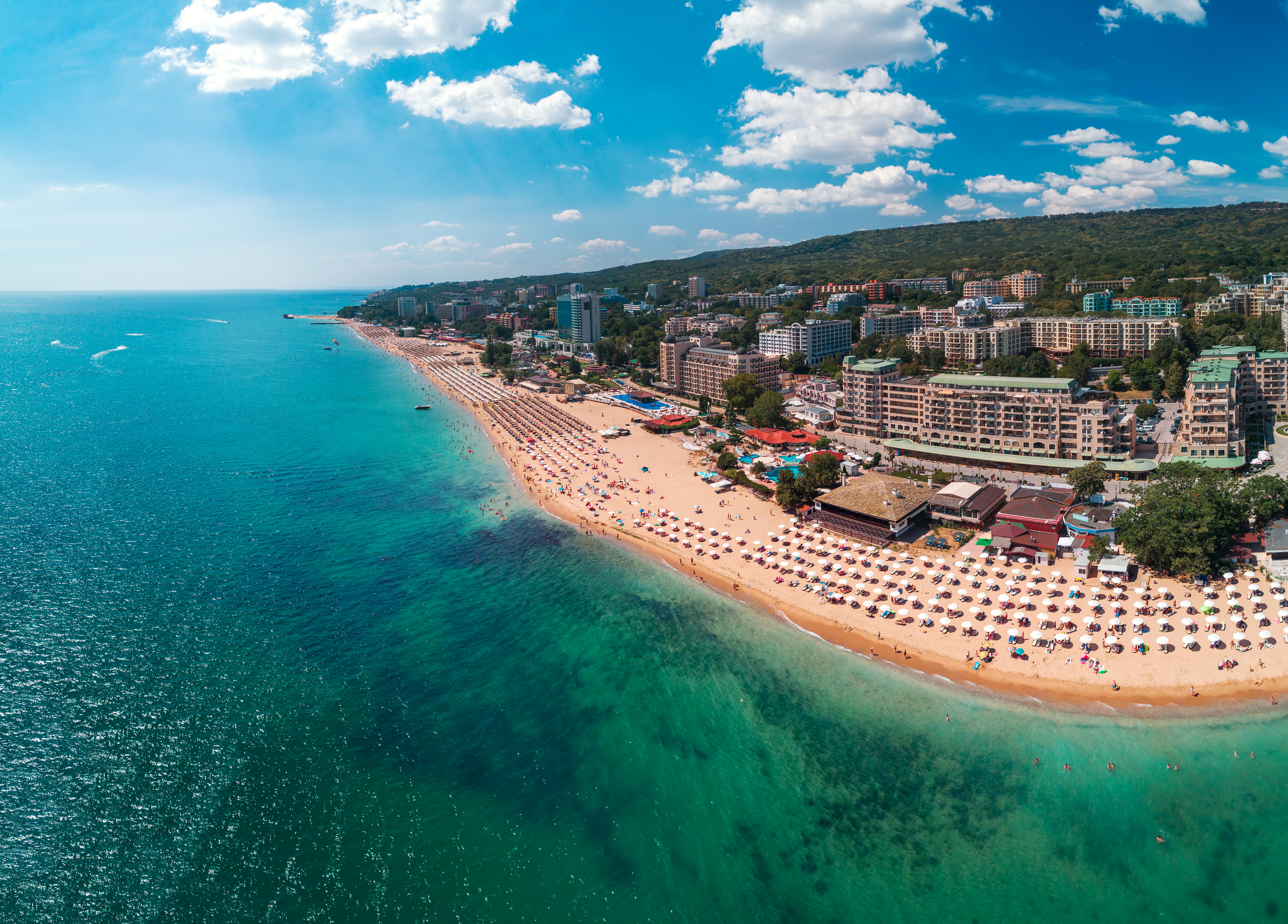 a beach with buildings and a body of water