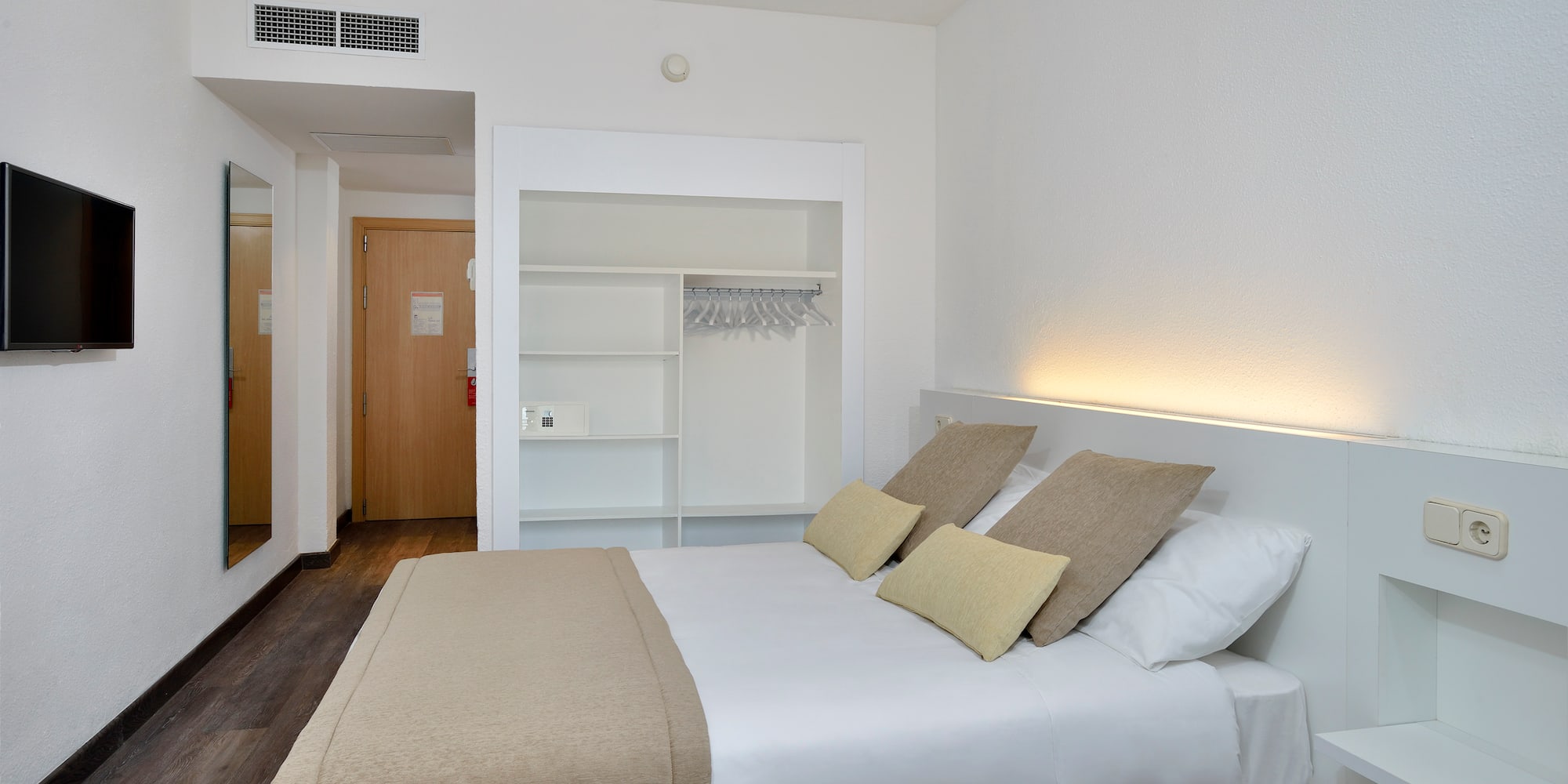 a bed with pillows in a room