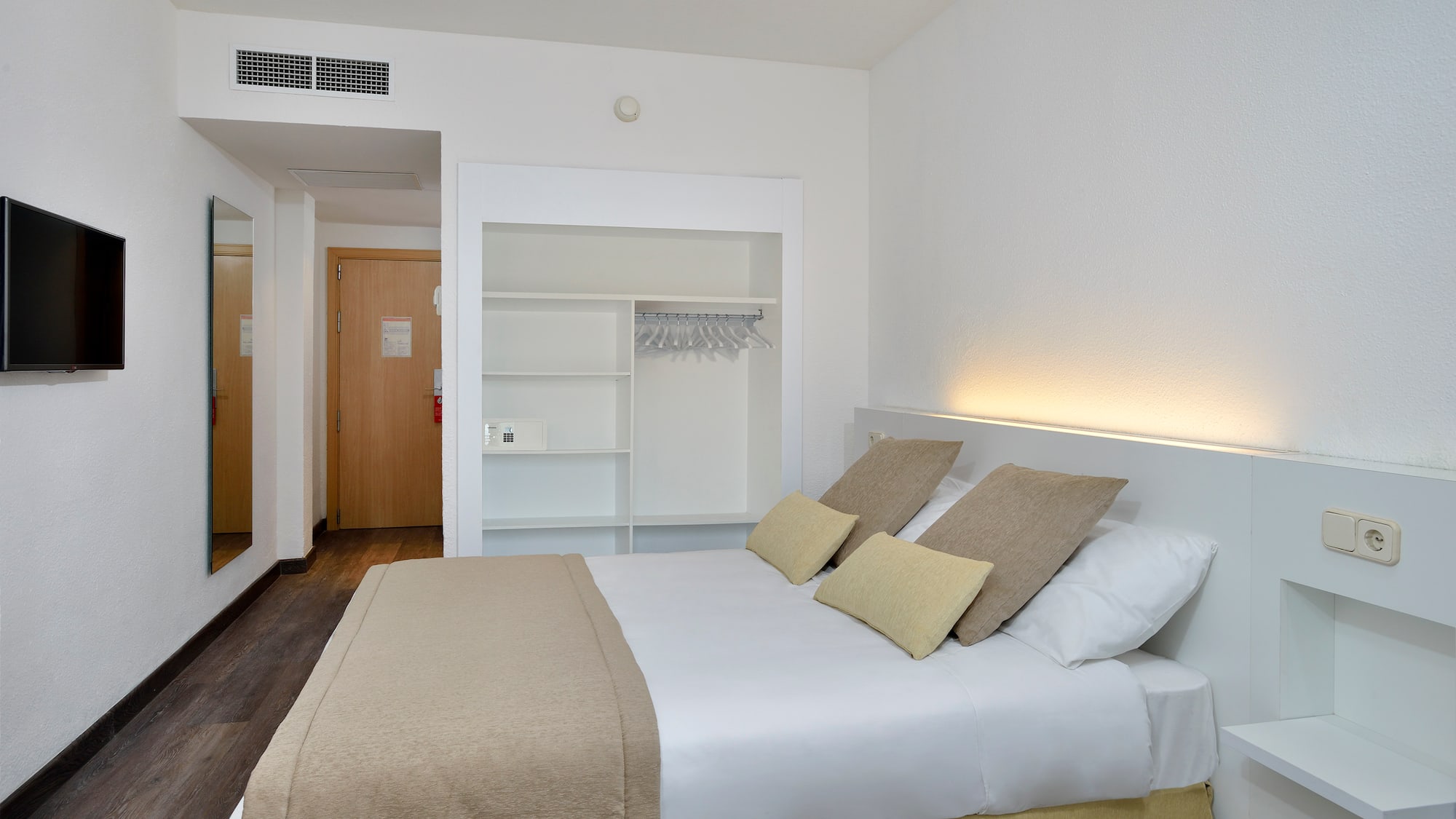 a bed with pillows in a room