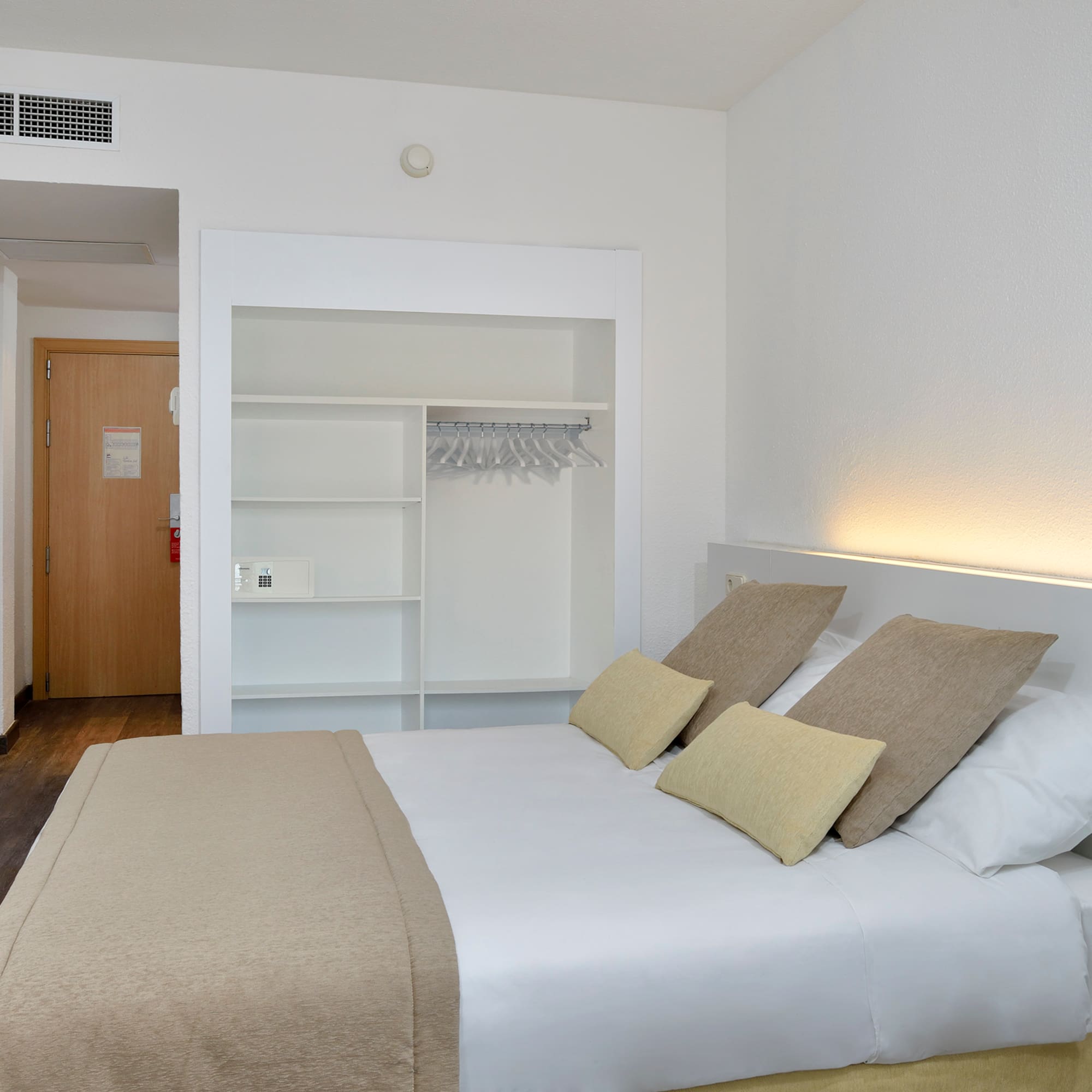 a bed with pillows in a room