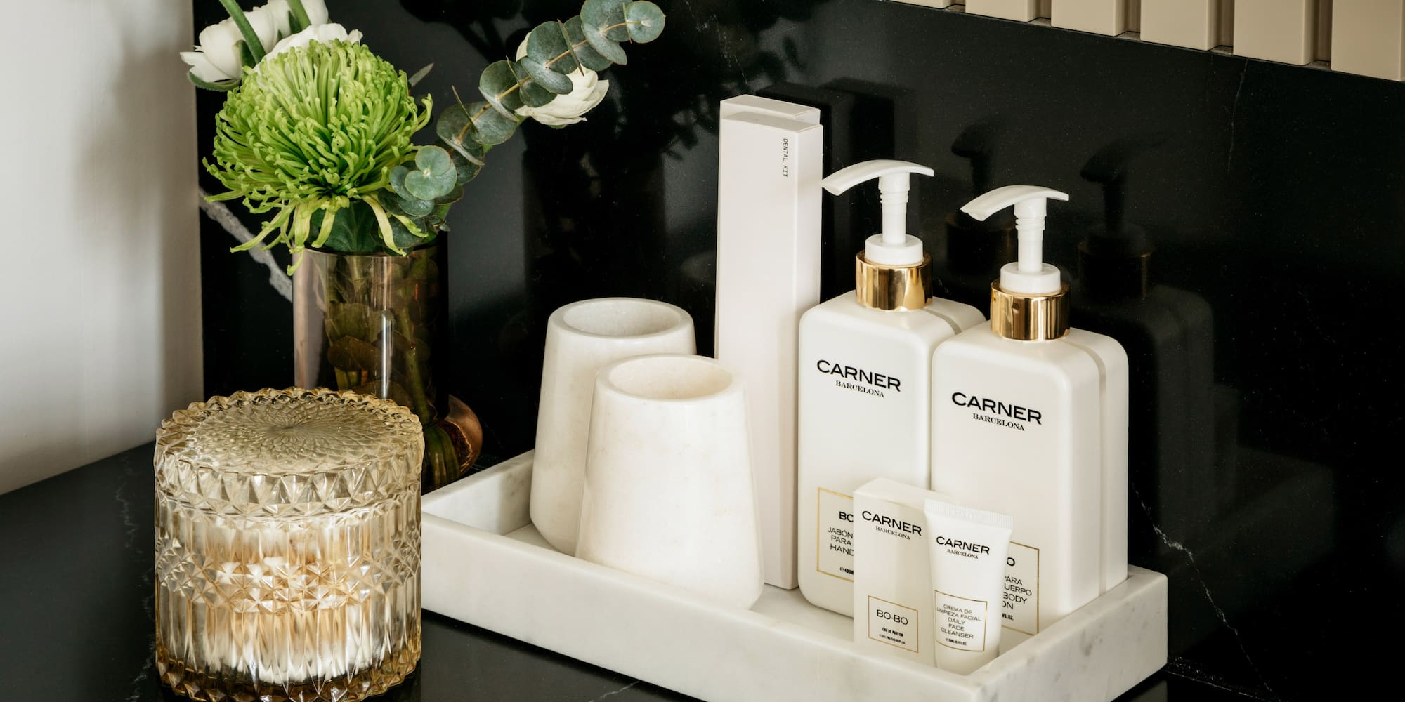 a group of white bottles and cups on a black counter