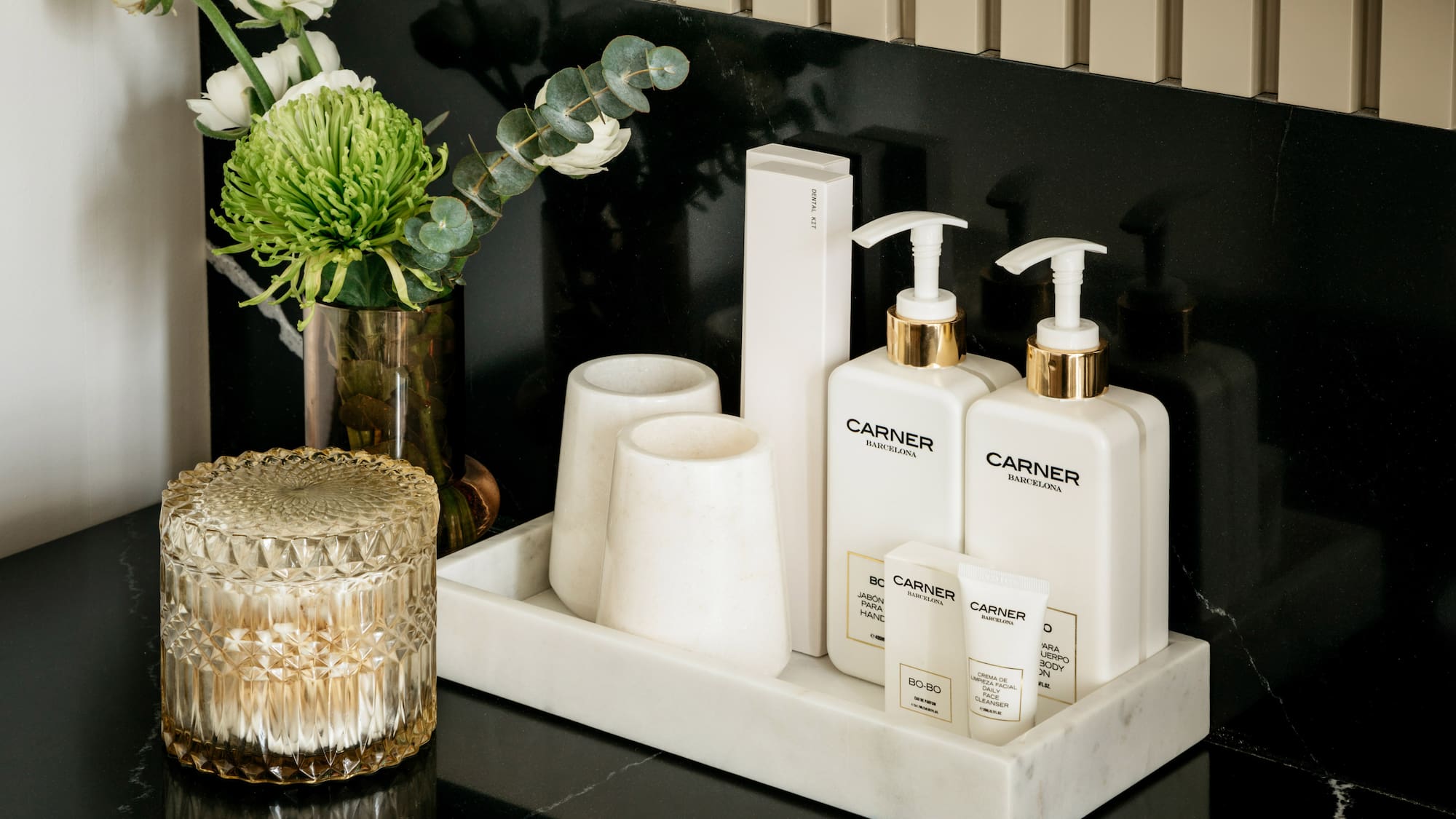 a group of white bottles and cups on a black counter