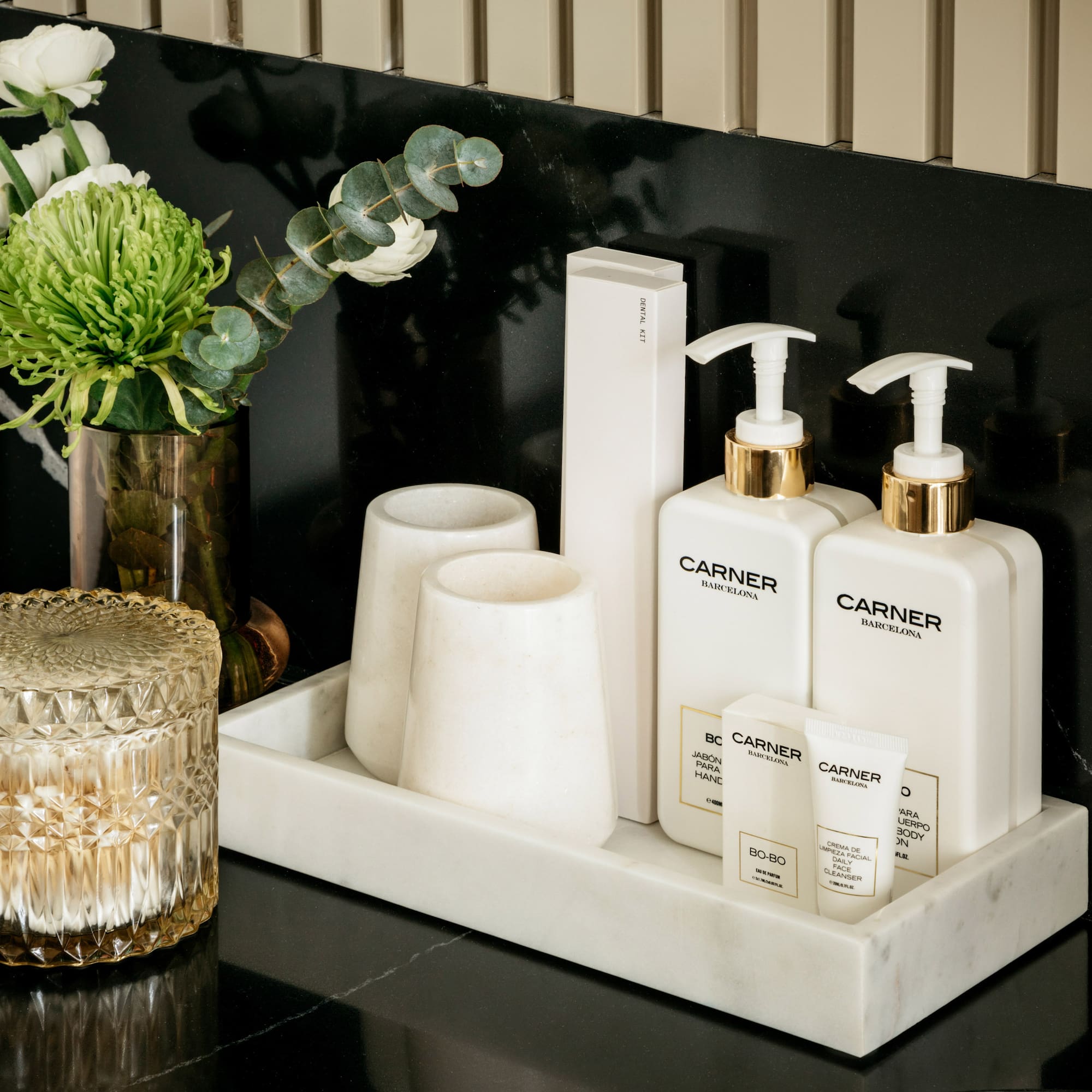 a group of white bottles and cups on a black counter