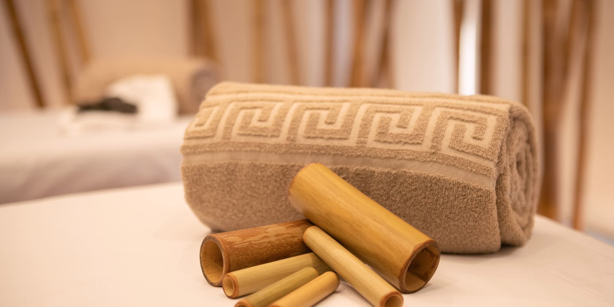 a rolled up towel and bamboo tubes