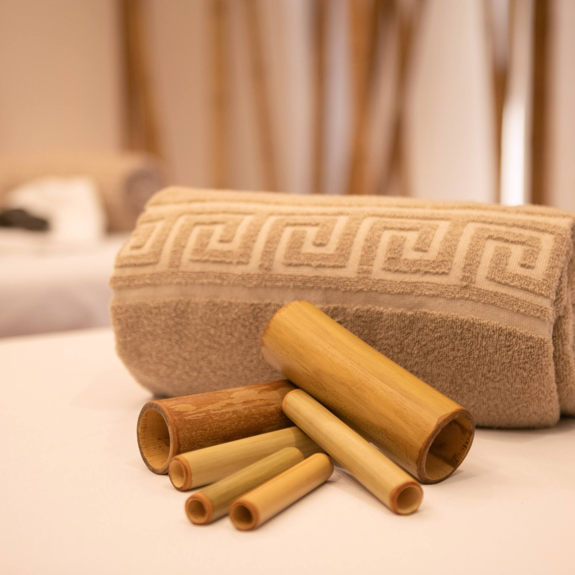 a rolled up towel and bamboo tubes