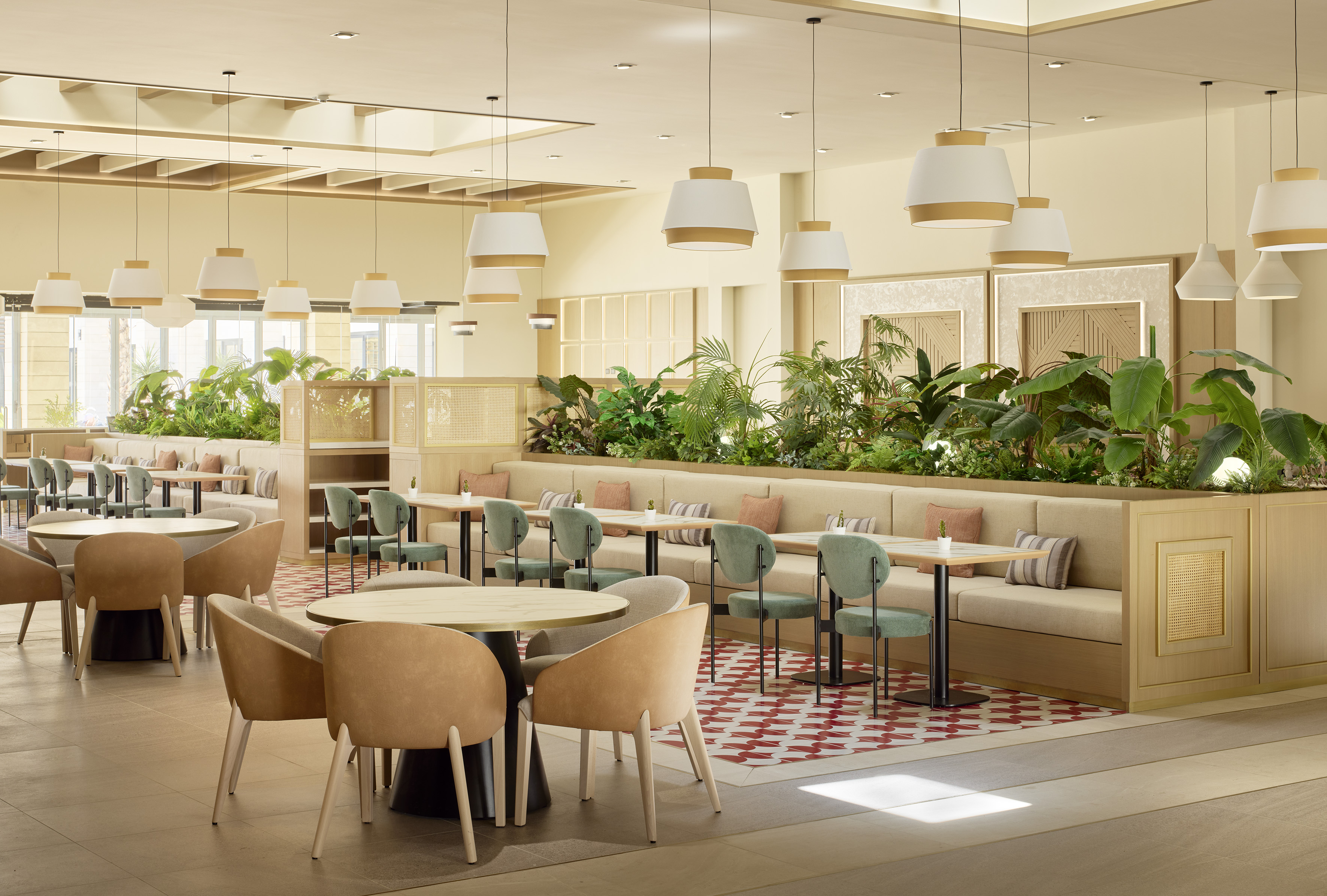 Modern restaurant dining area with lush indoor plants and stylish seating.