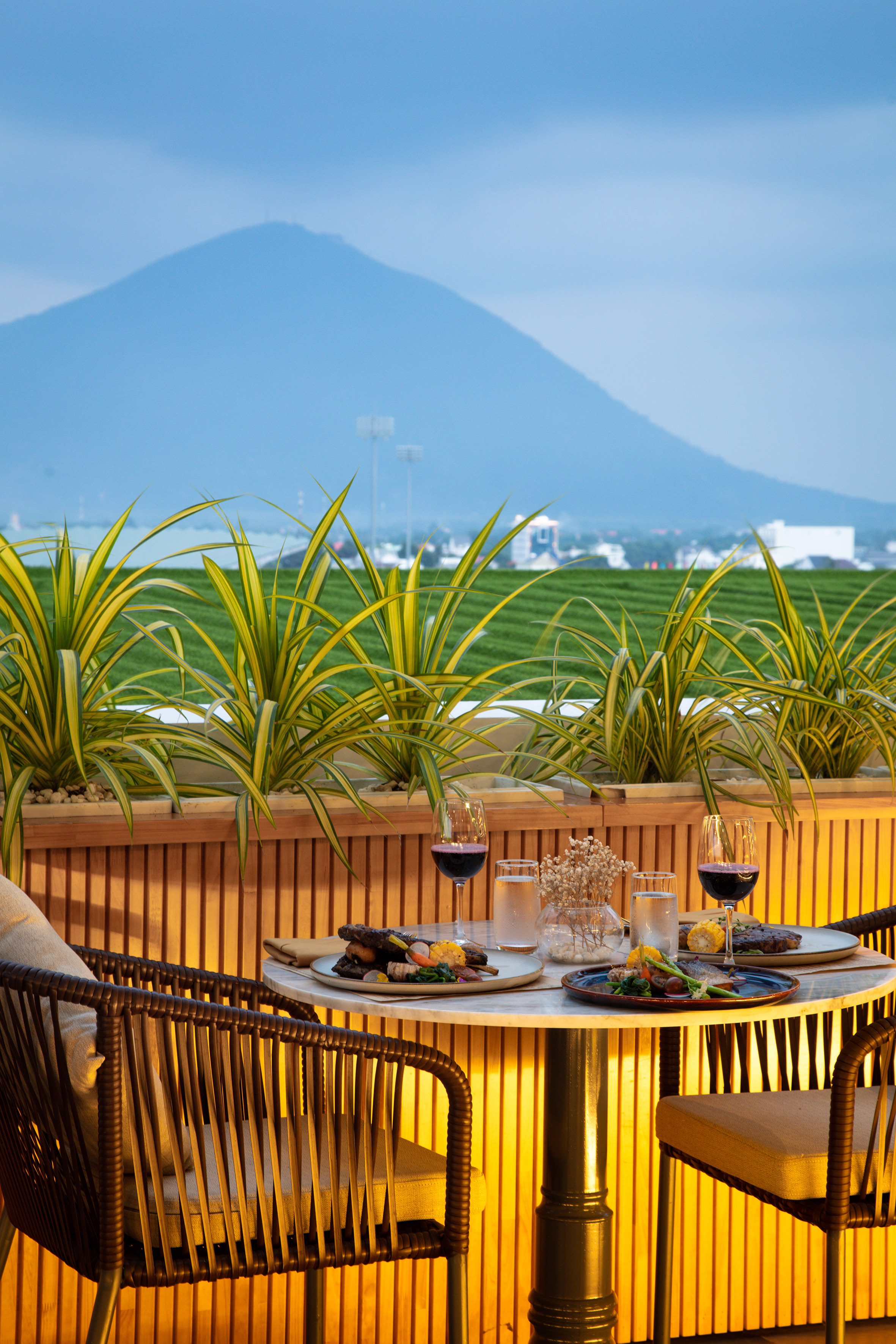 a table with food on it and a view of a mountain in the background