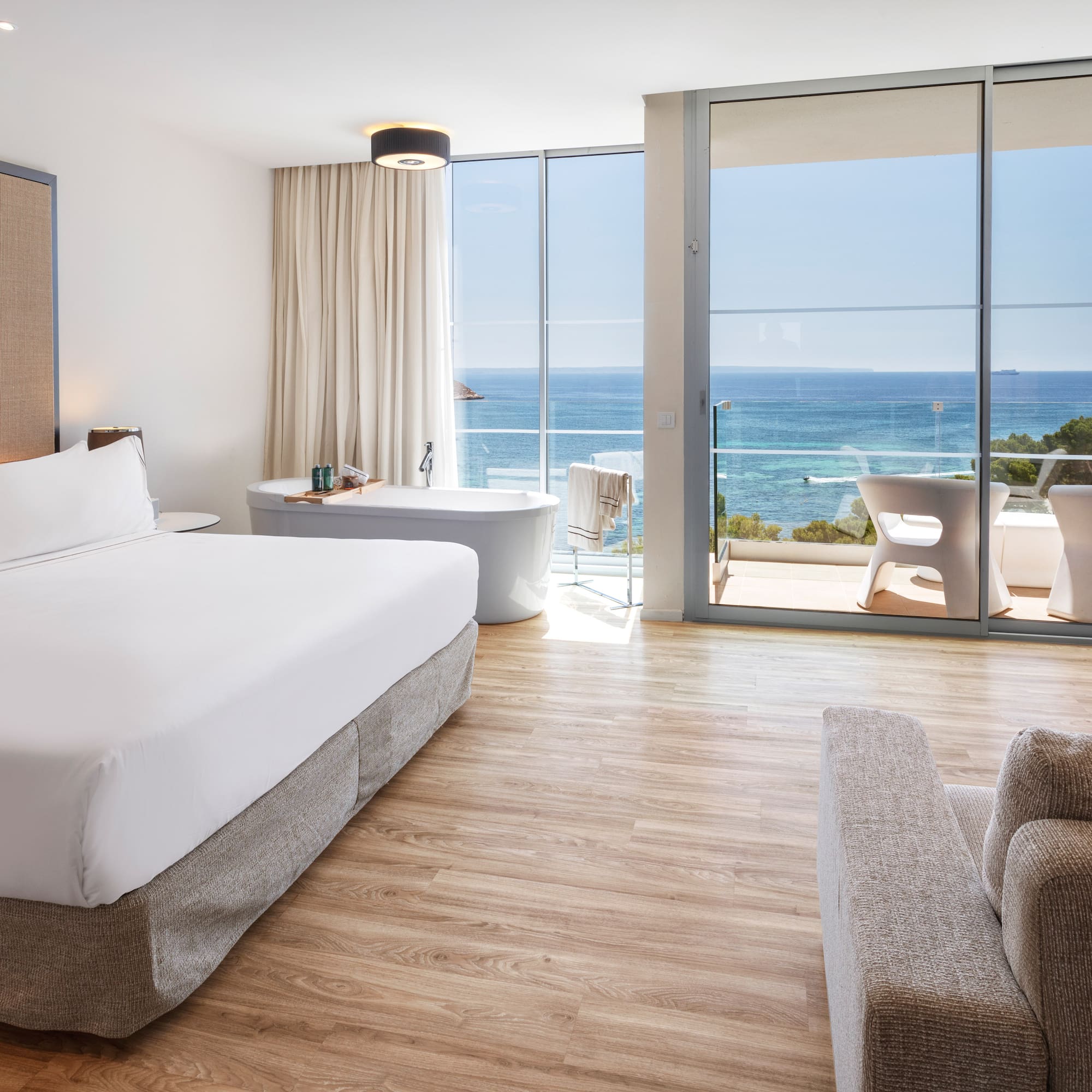 a bedroom with a large window overlooking the ocean