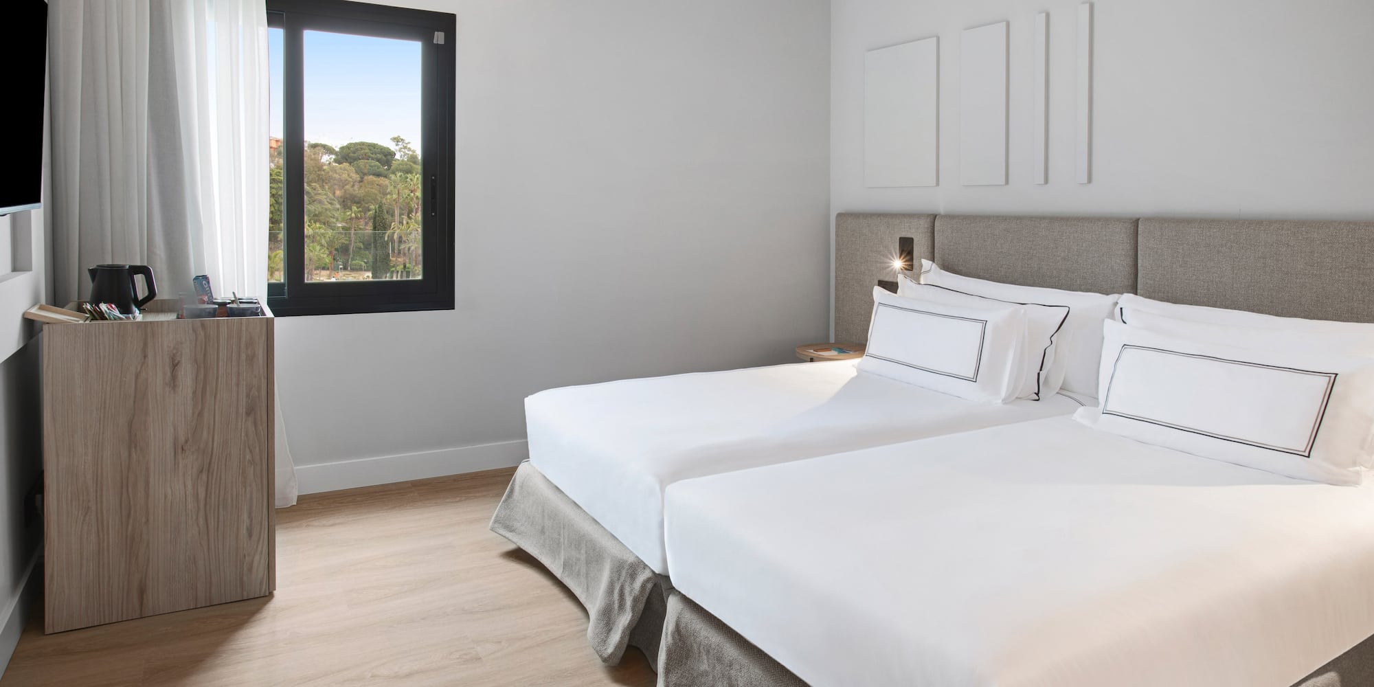 a room with two beds and a window