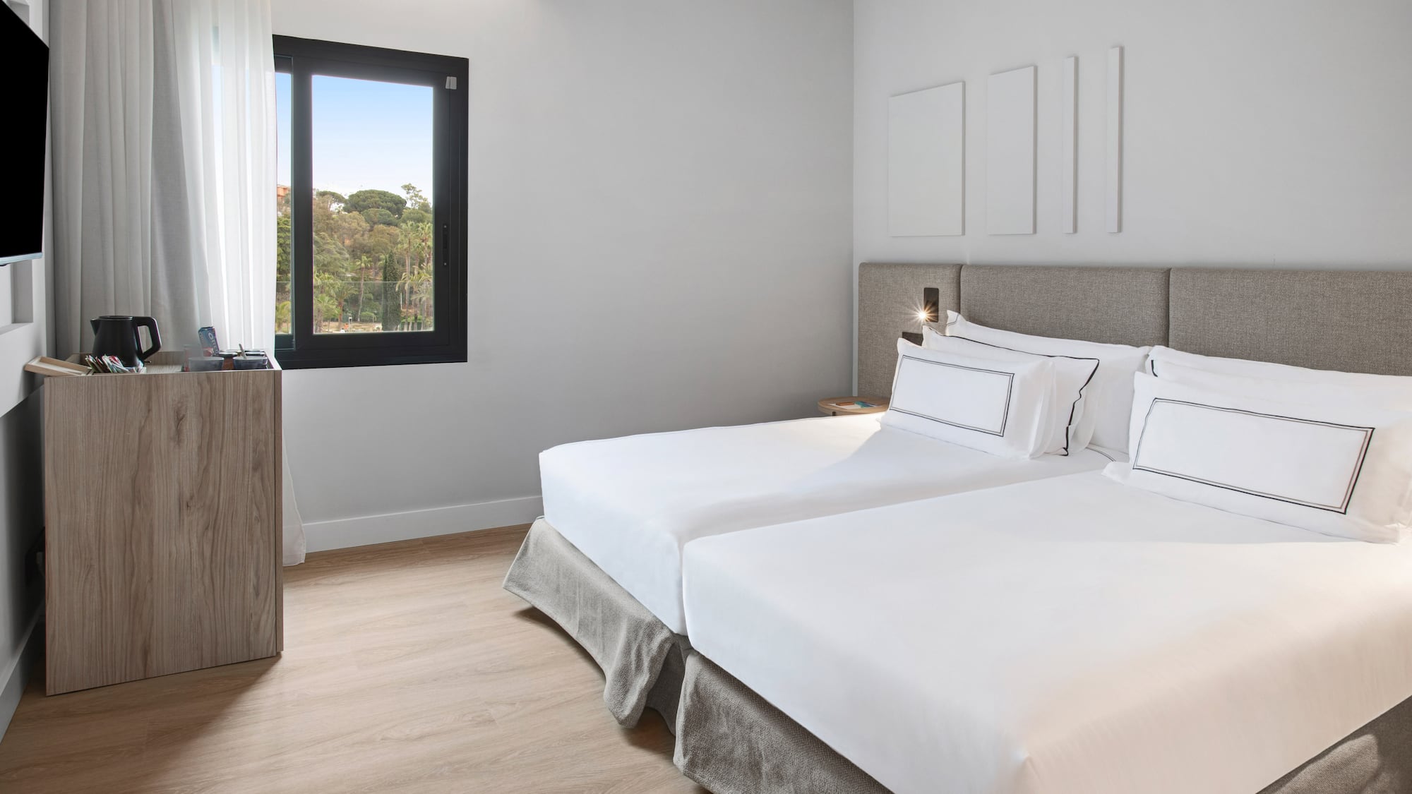 a room with two beds and a window