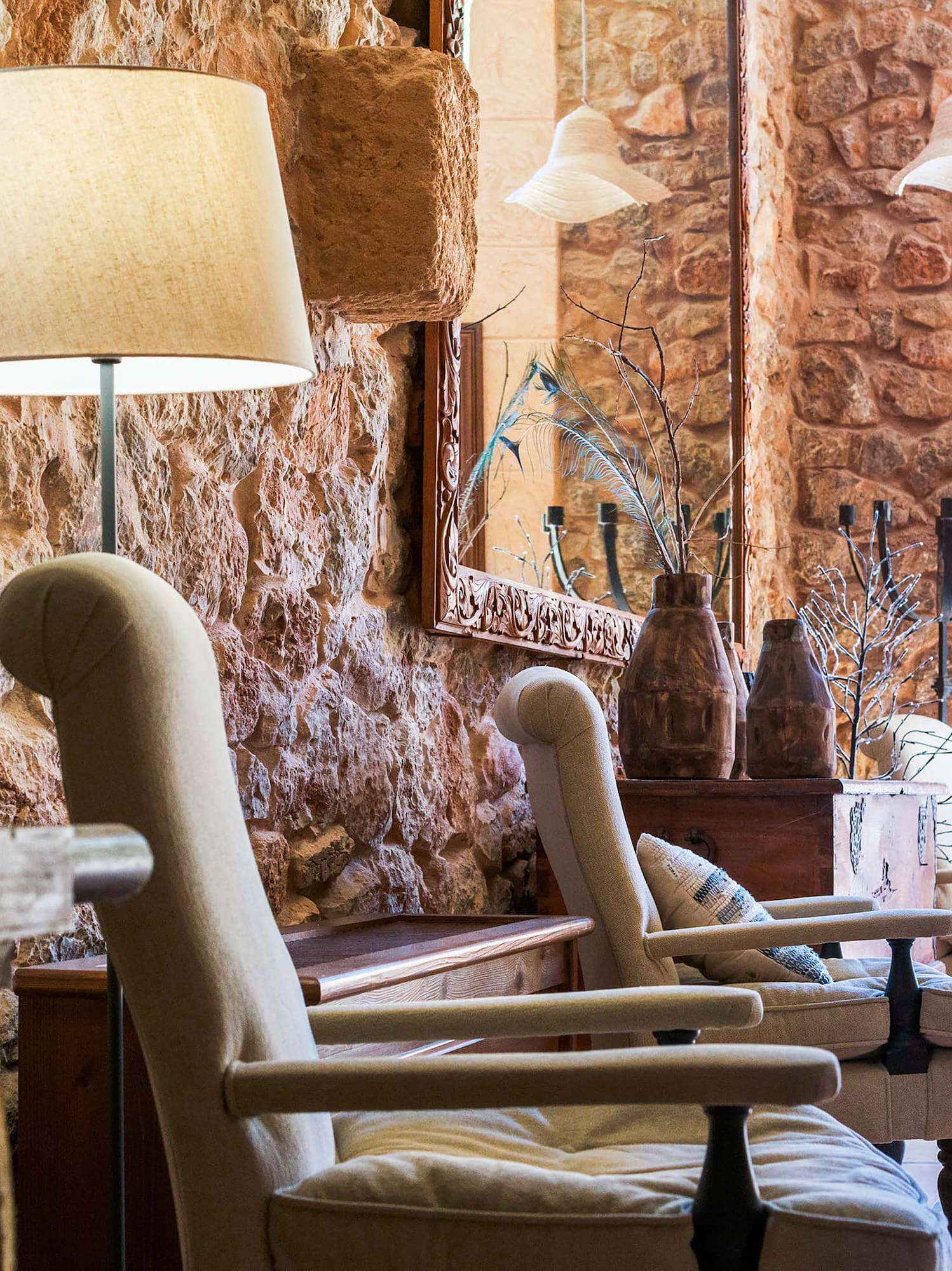 a room with a stone wall and chairs