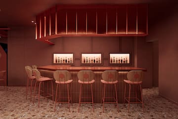 a bar with chairs and bottles in it