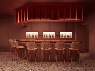 a bar with chairs and bottles in it