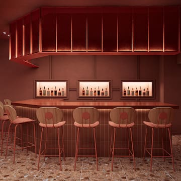 a bar with chairs and bottles in it