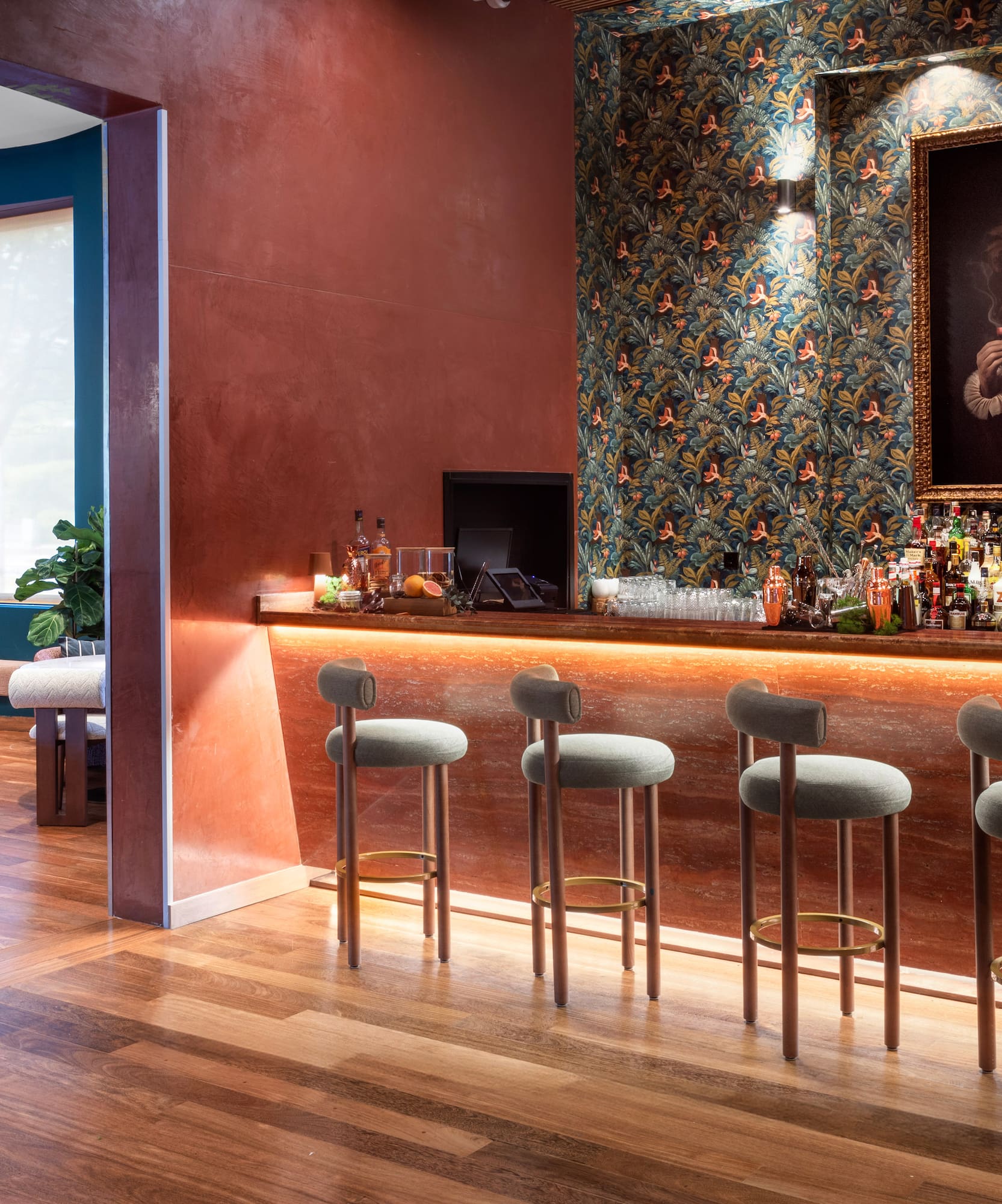 a bar with stools and a painting of a lion