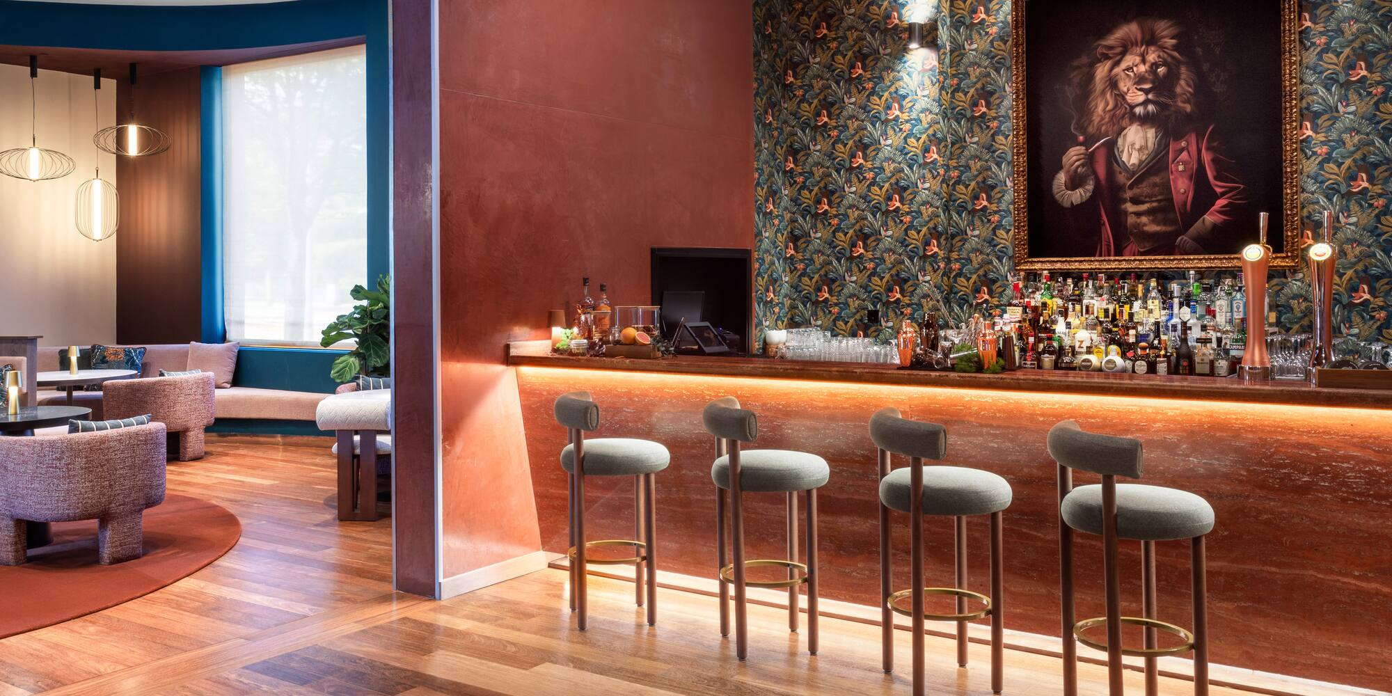 a bar with stools and a painting of a lion