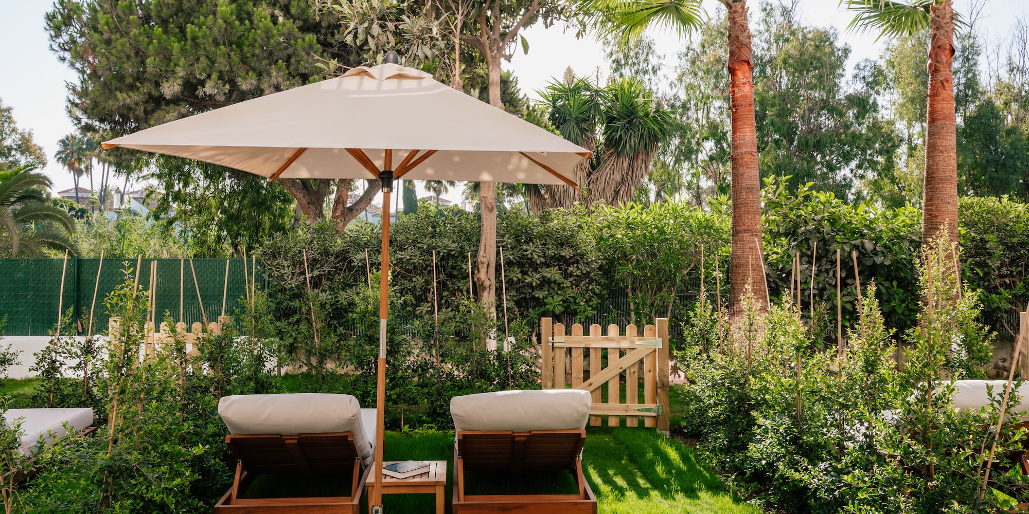 a lawn chairs and umbrella in a backyard