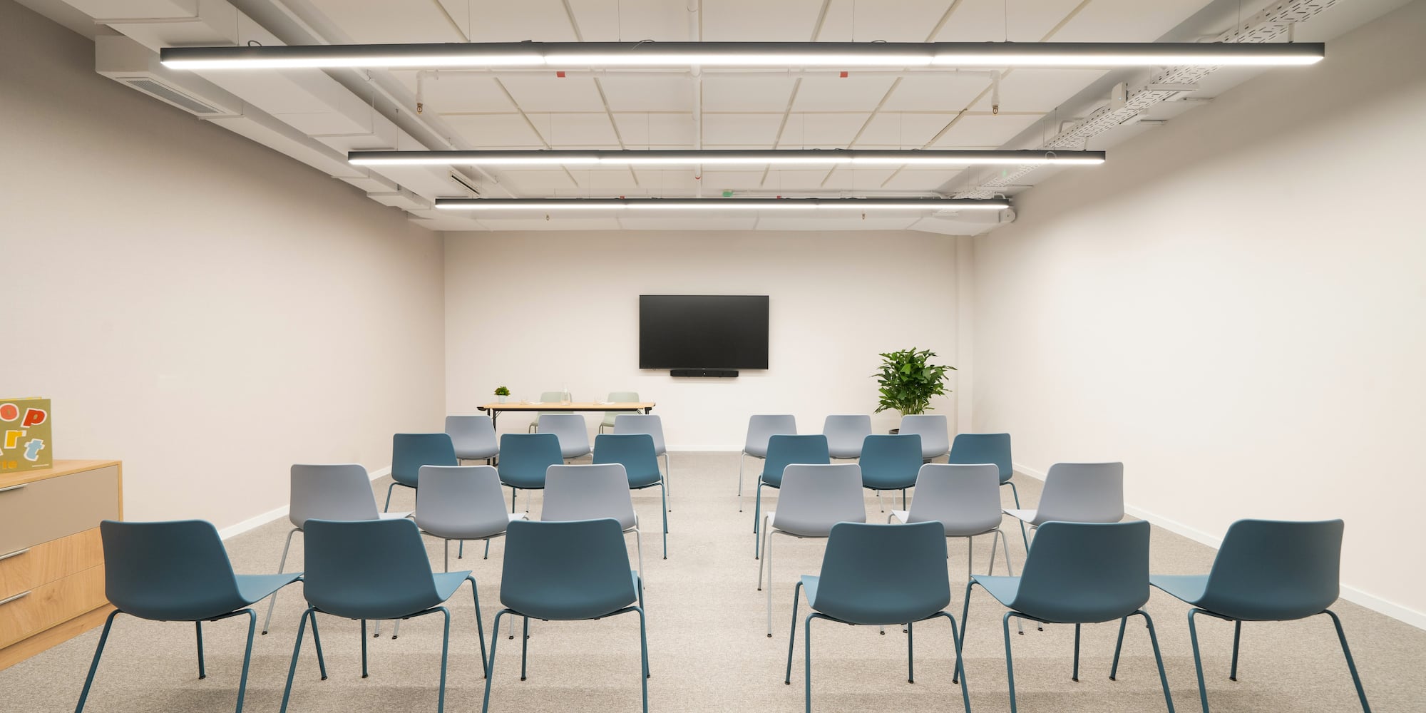 a room with many chairs and a tv