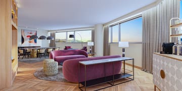 a living room with purple couches and a table