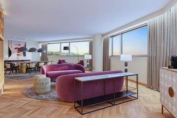 a living room with purple couches and a table