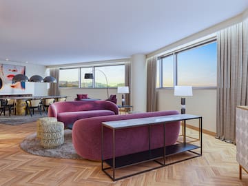 a living room with purple couches and a table
