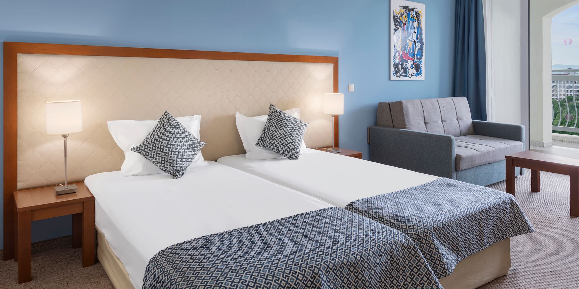 a room with two beds and a couch