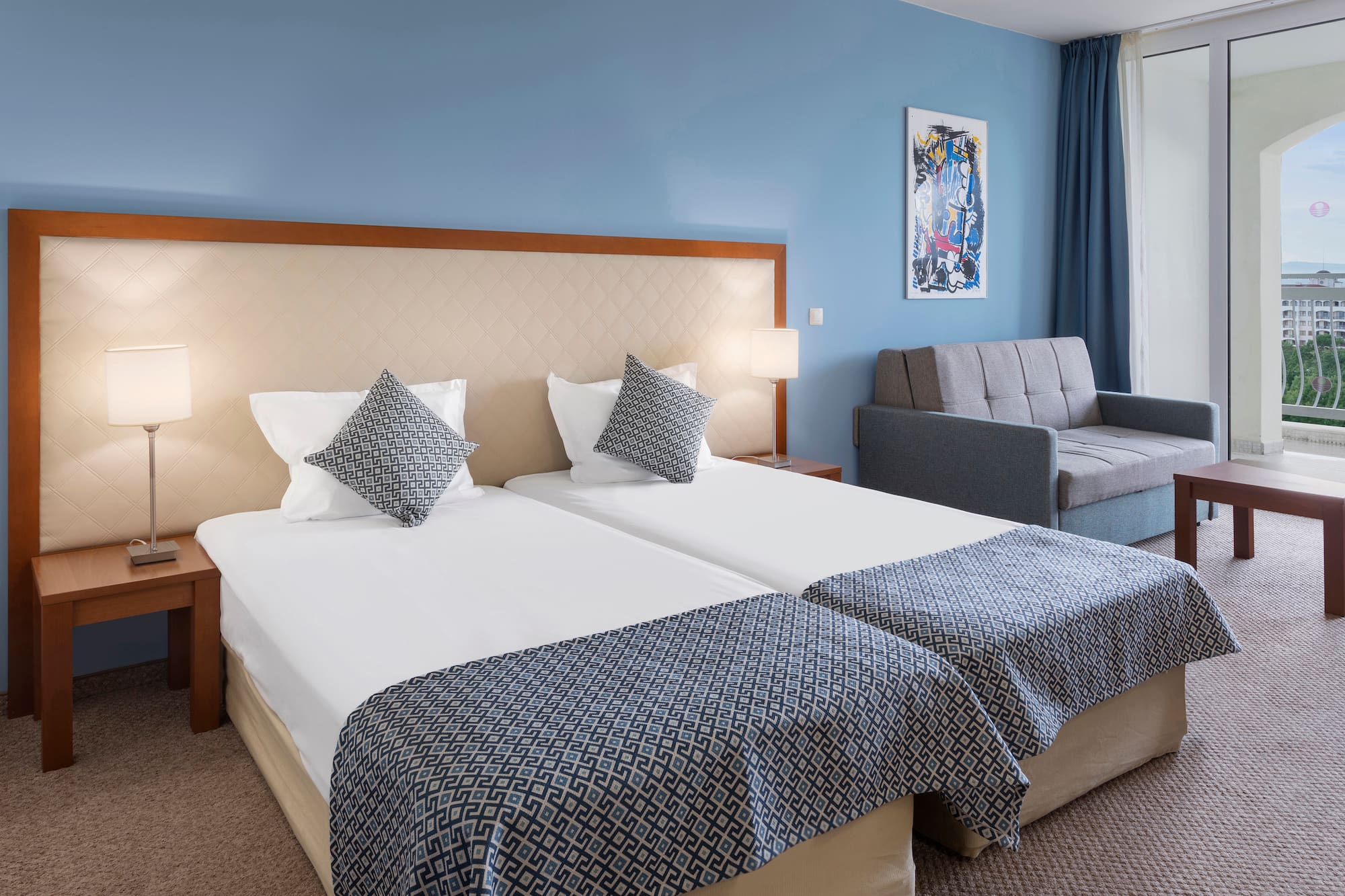 a room with two beds and a couch