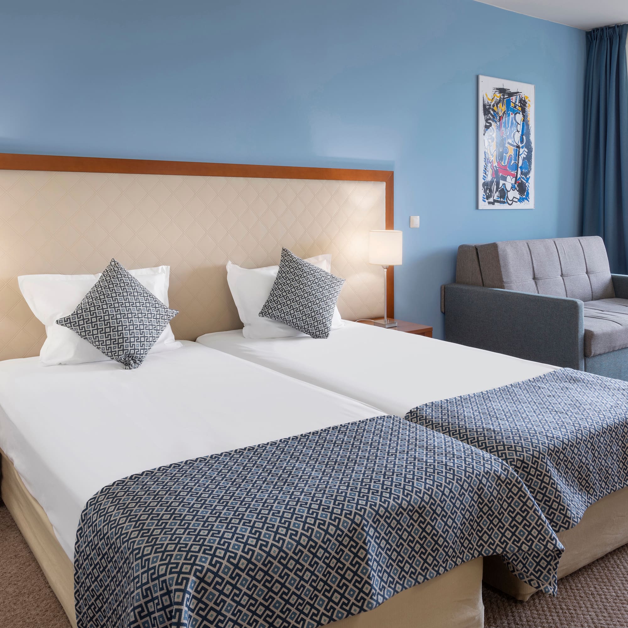 a room with two beds and a couch