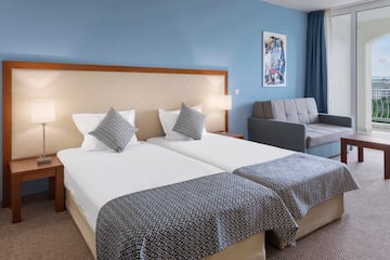 a room with two beds and a couch