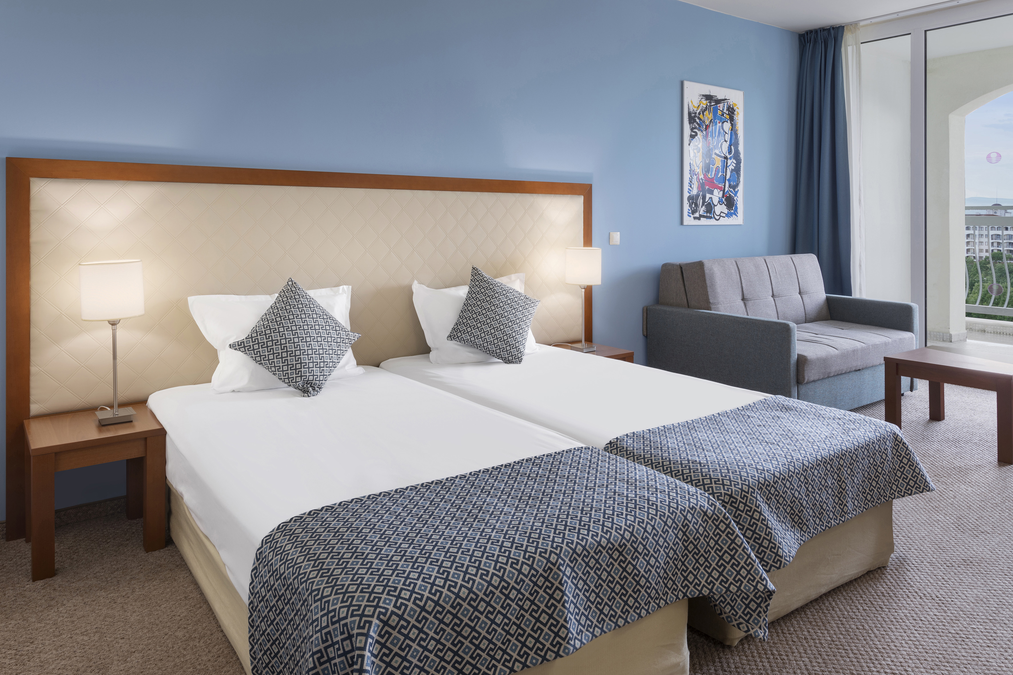 a room with two beds and a couch