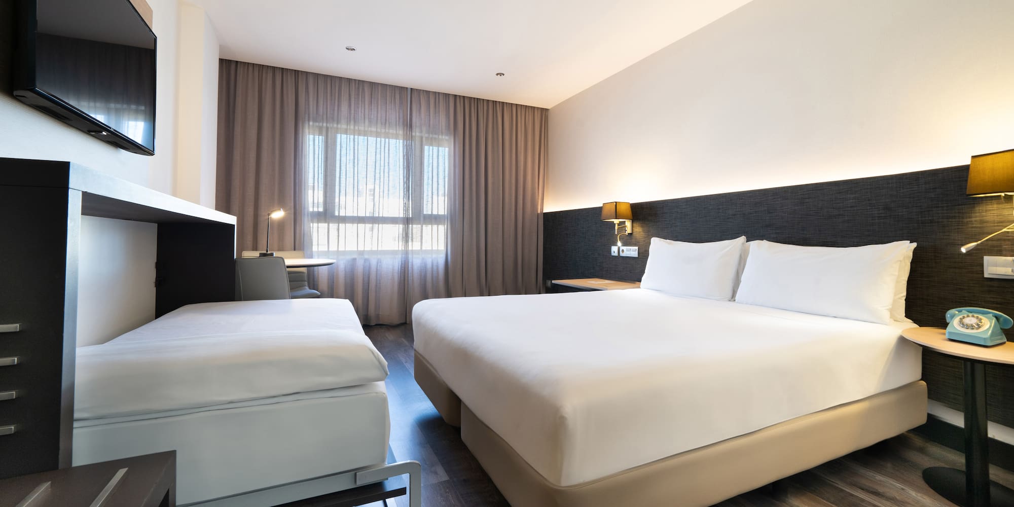 a room with two beds and a fireplace