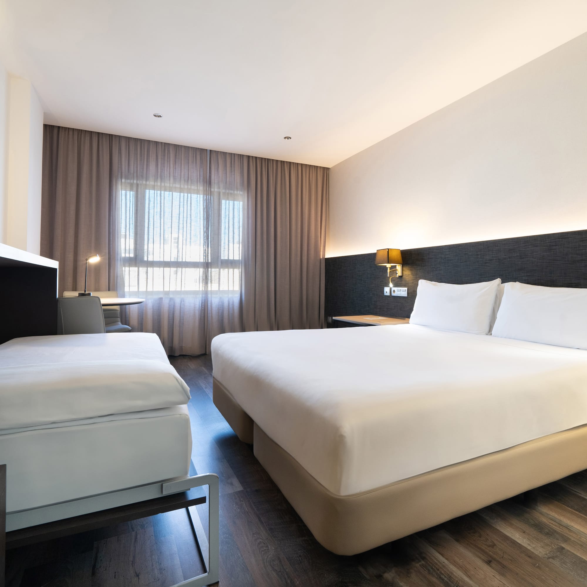 a room with two beds and a fireplace