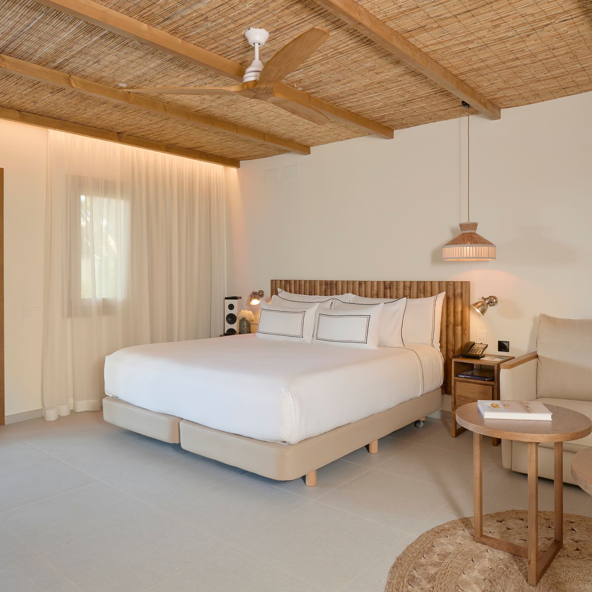 a bedroom with a bed and a chair