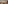 Modern meeting space with large conference table, beige chairs, and projector screen.
