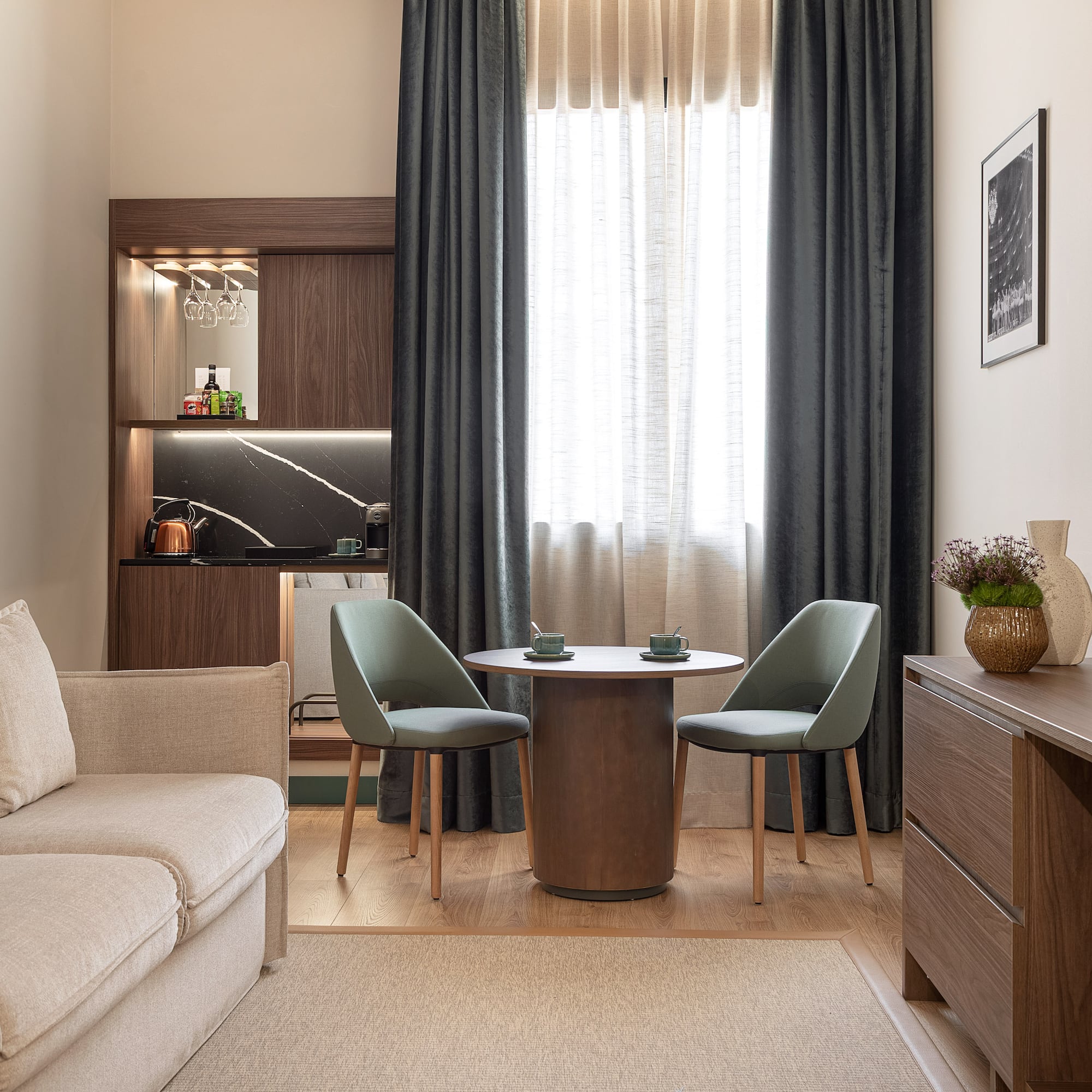 a living room with a table and chairs