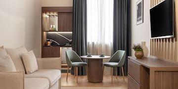 a living room with a table and chairs