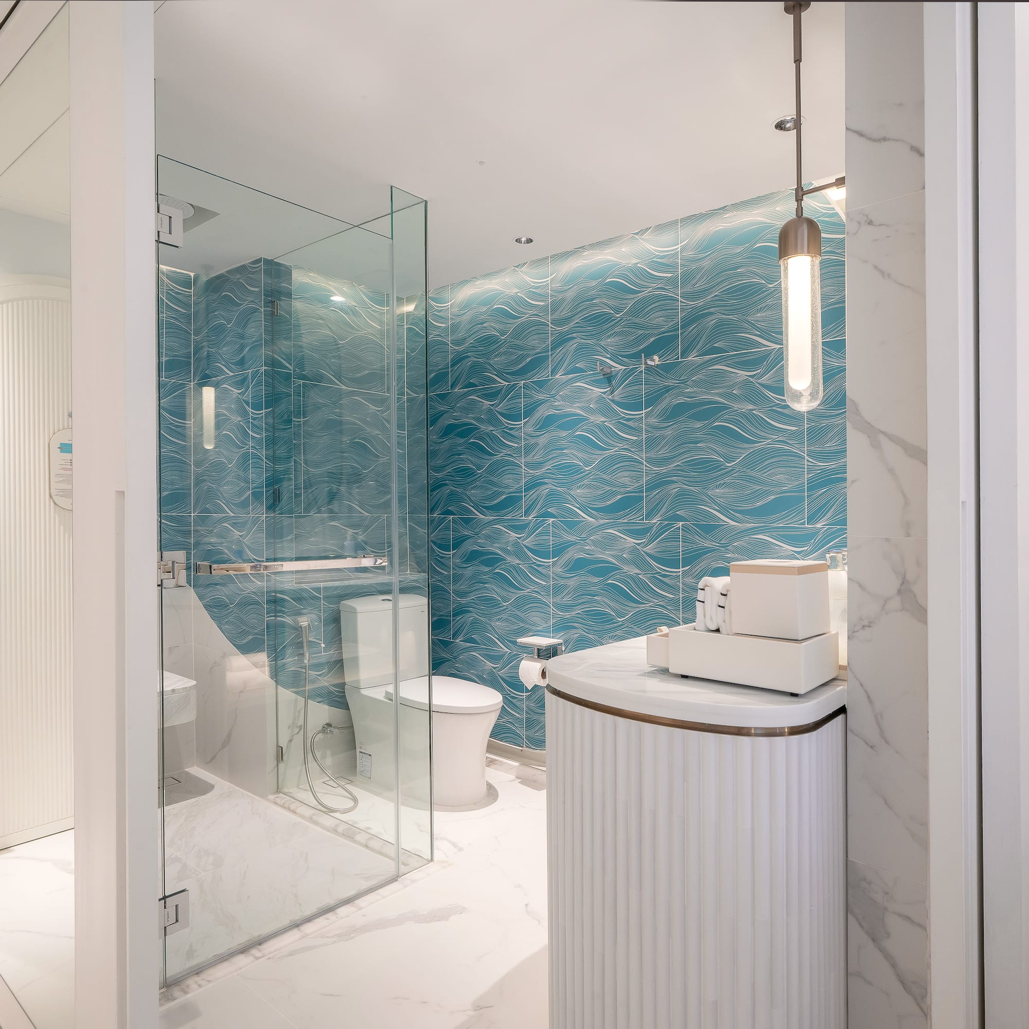 a bathroom with a blue wall and a toilet