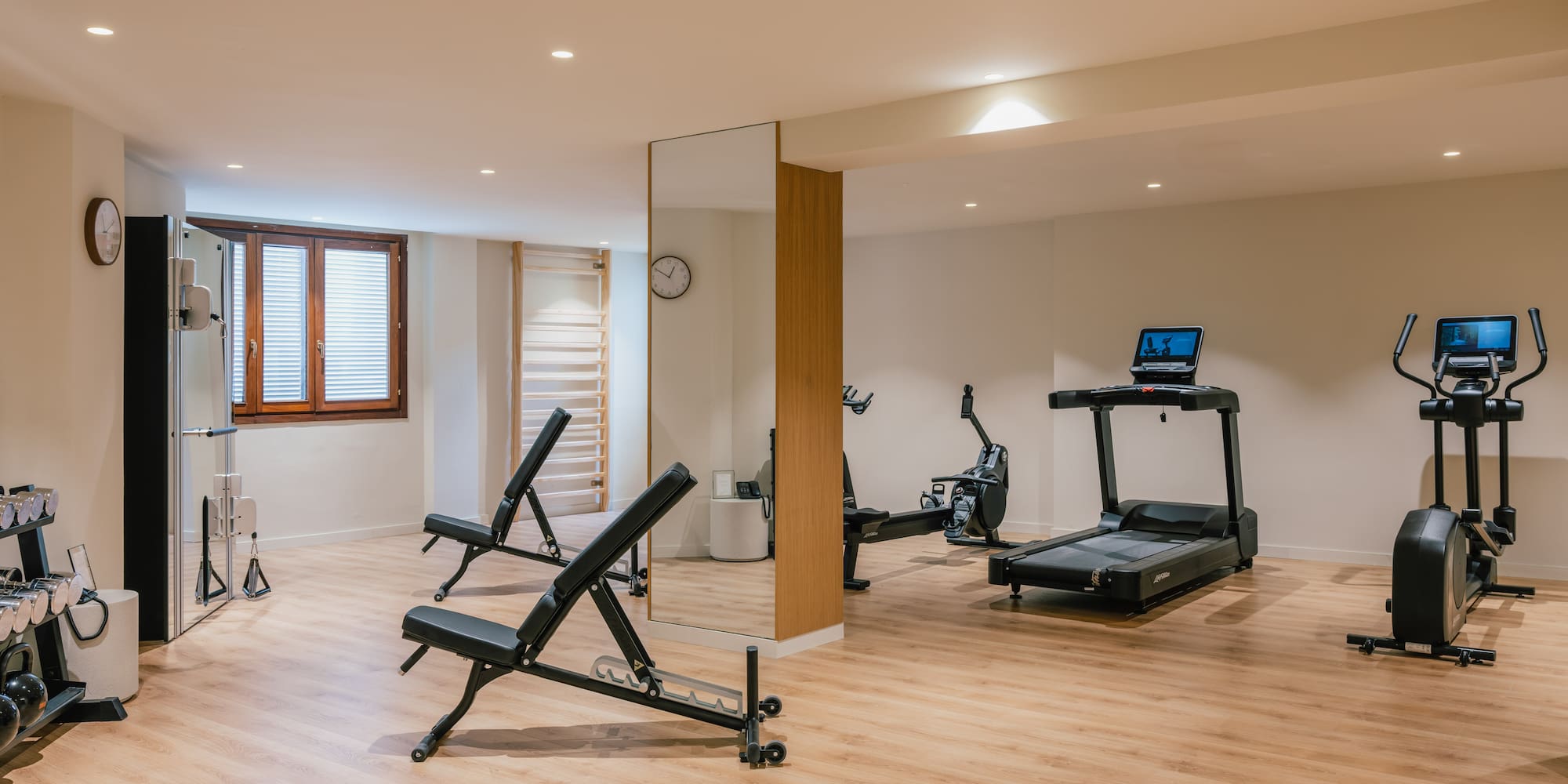 a room with exercise equipment and a mirror