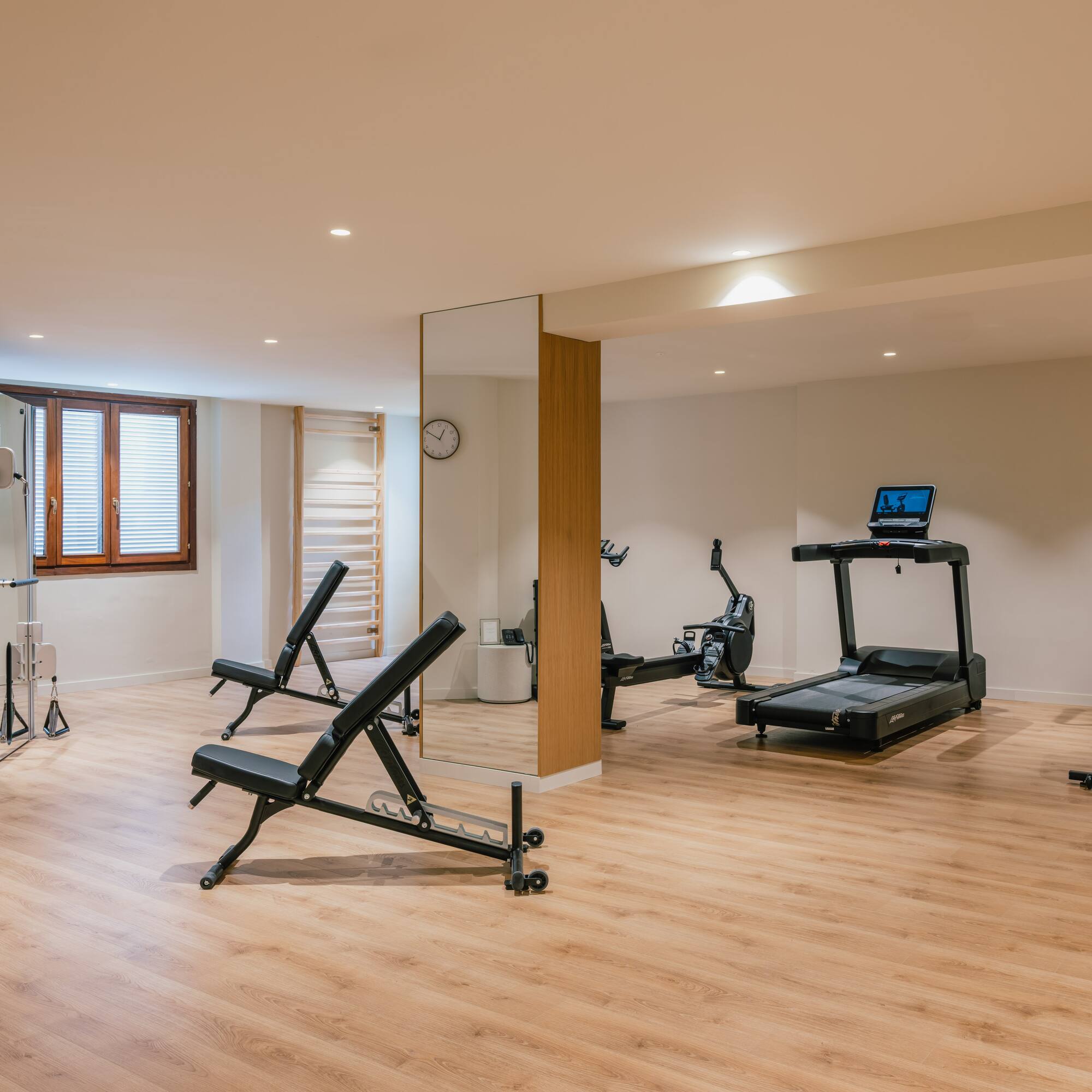 a room with exercise equipment and a mirror