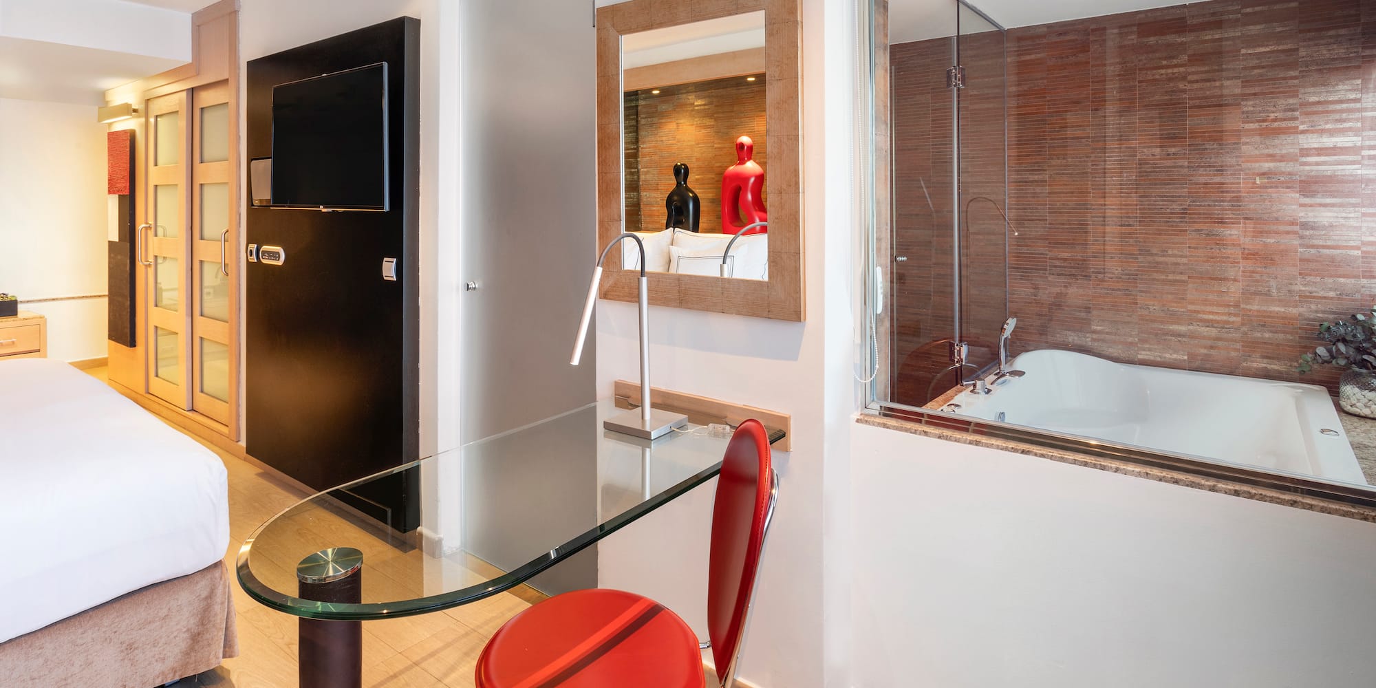 a room with a glass table and a tub