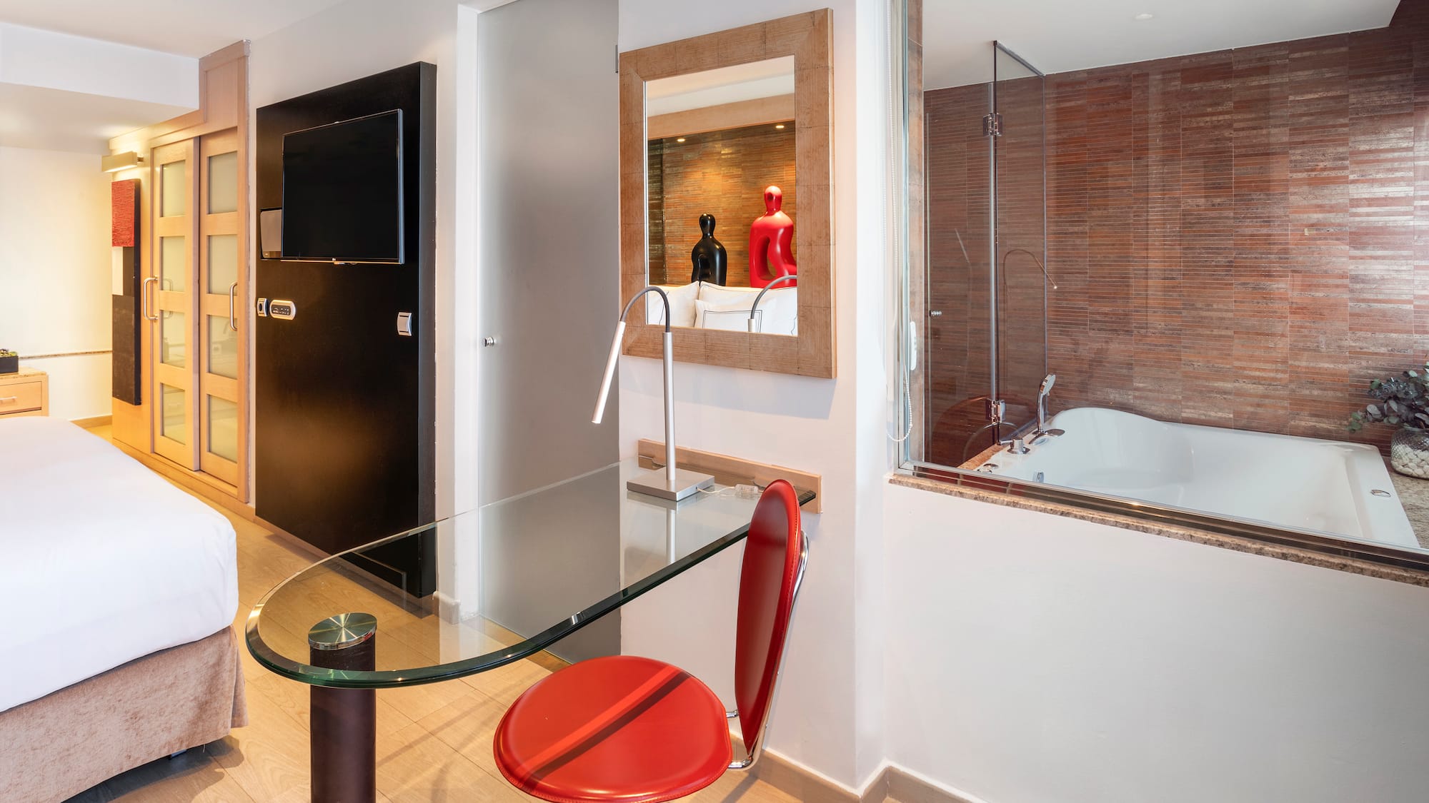 a room with a glass table and a tub