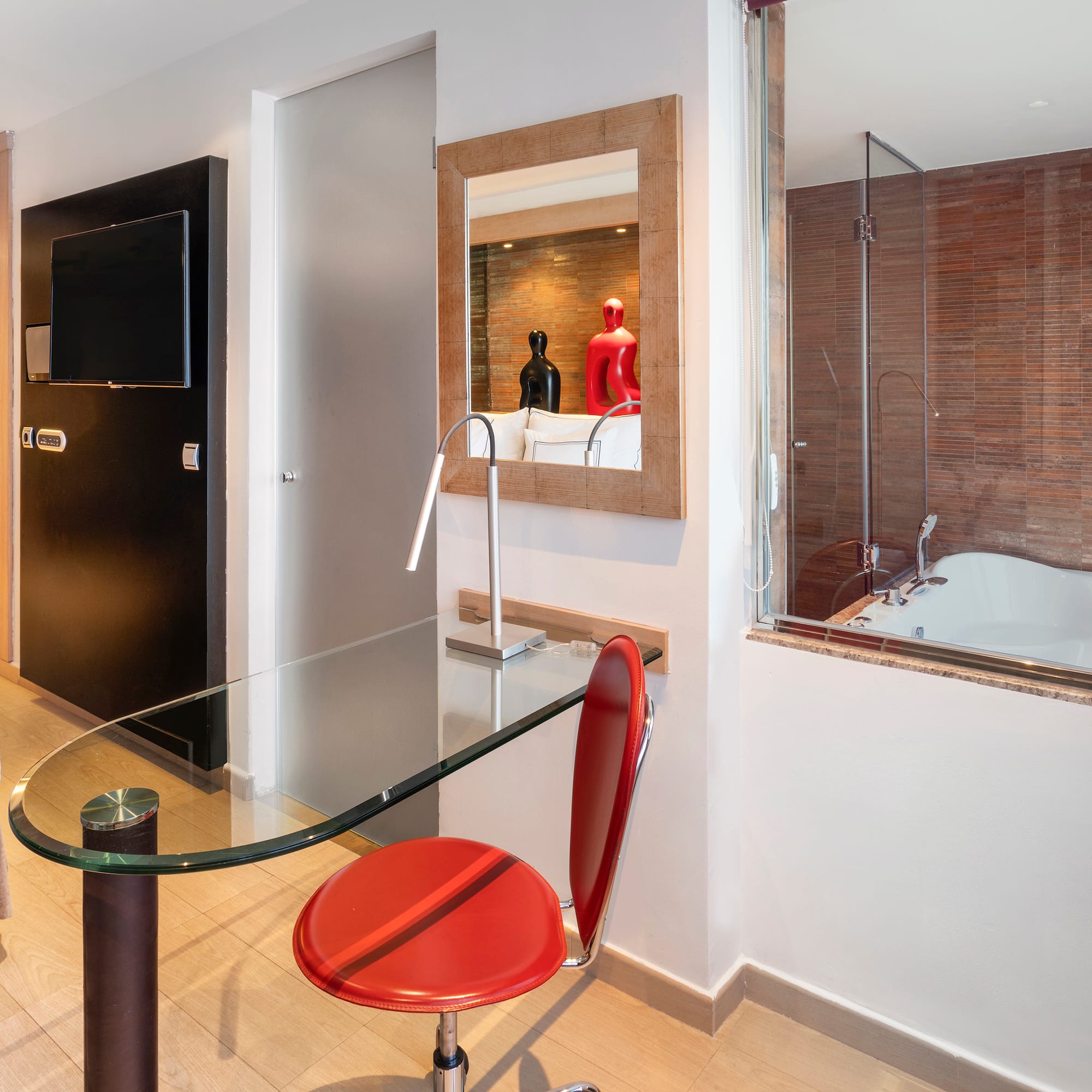 a room with a glass table and a tub