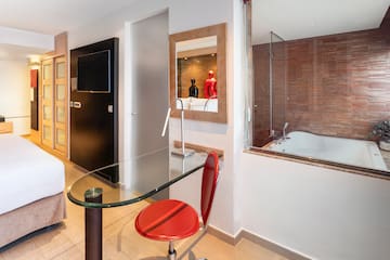 a room with a glass table and a tub