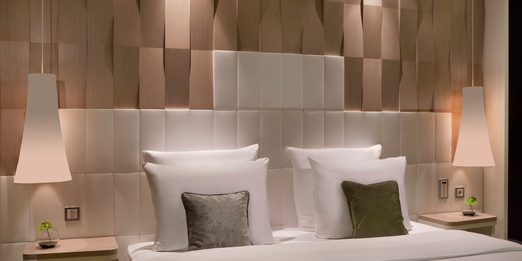 a bed with pillows and a table