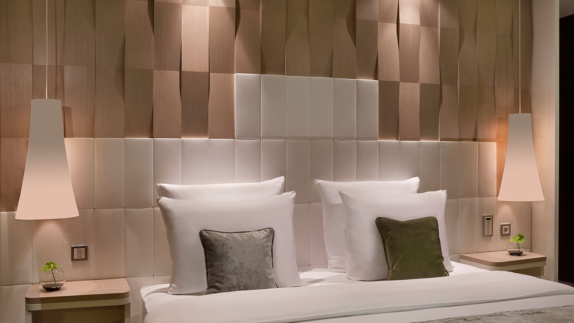 a bed with pillows and a table