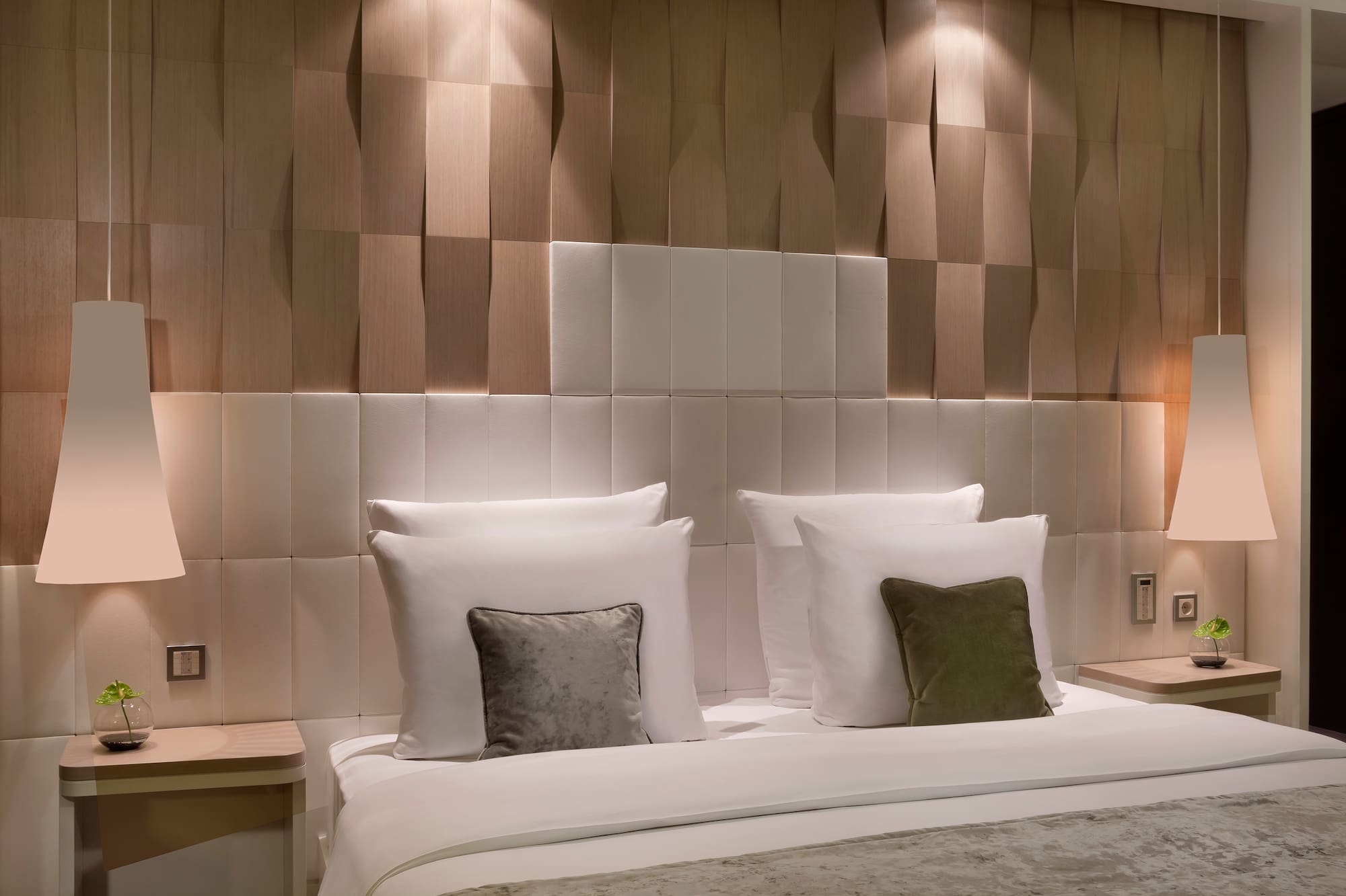 a bed with pillows and a table