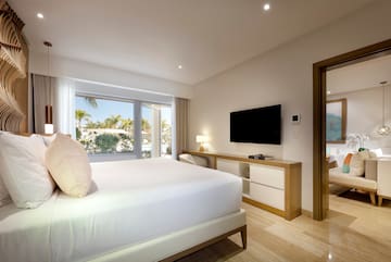 a bedroom with a television and a bed