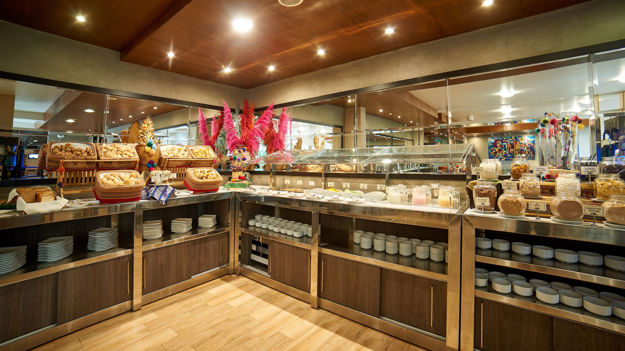 Hotel breakfast buffet showcasing bread, pastries, cereals, and milk.