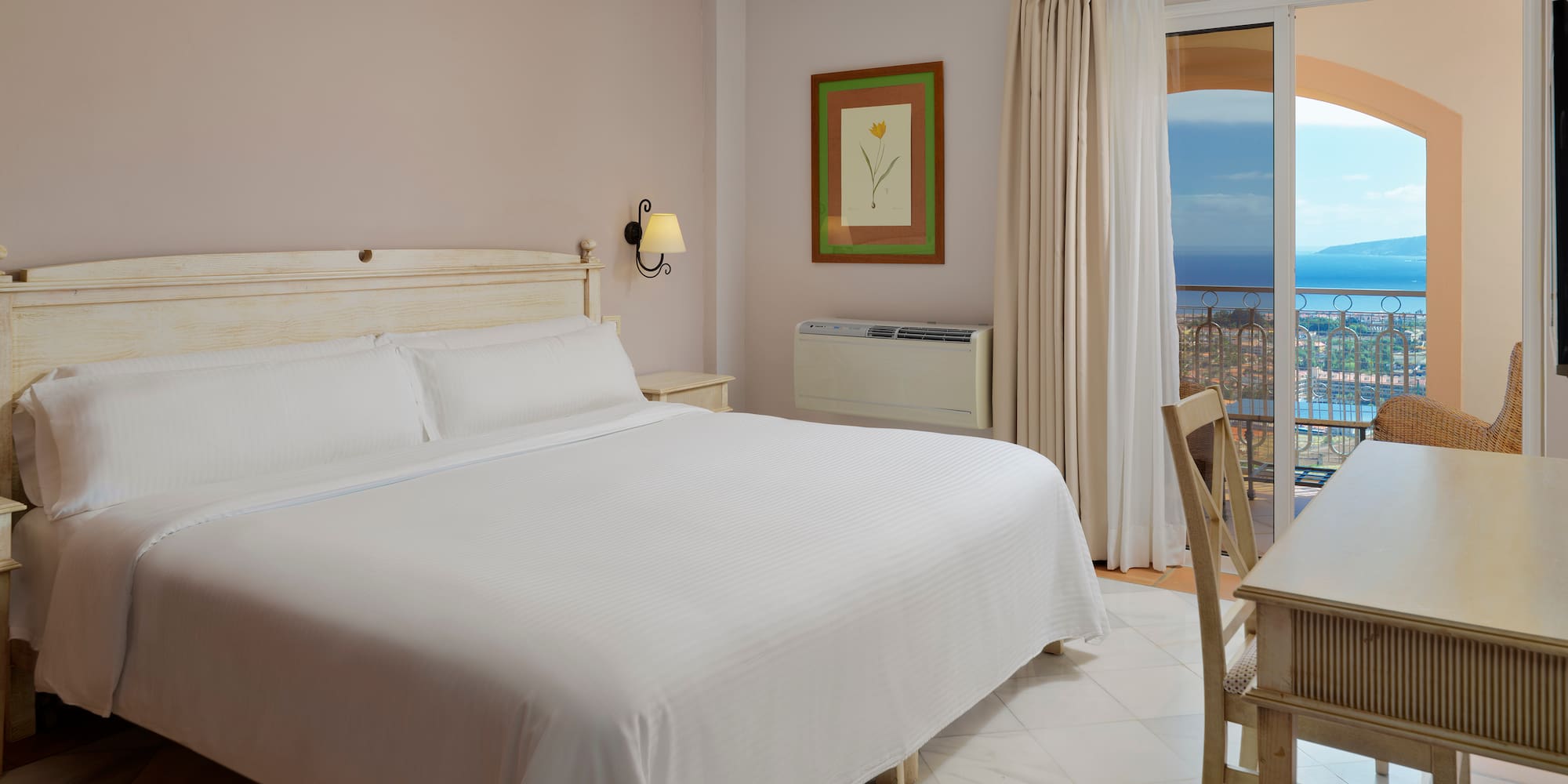 a bedroom with a bed and a table and chairs