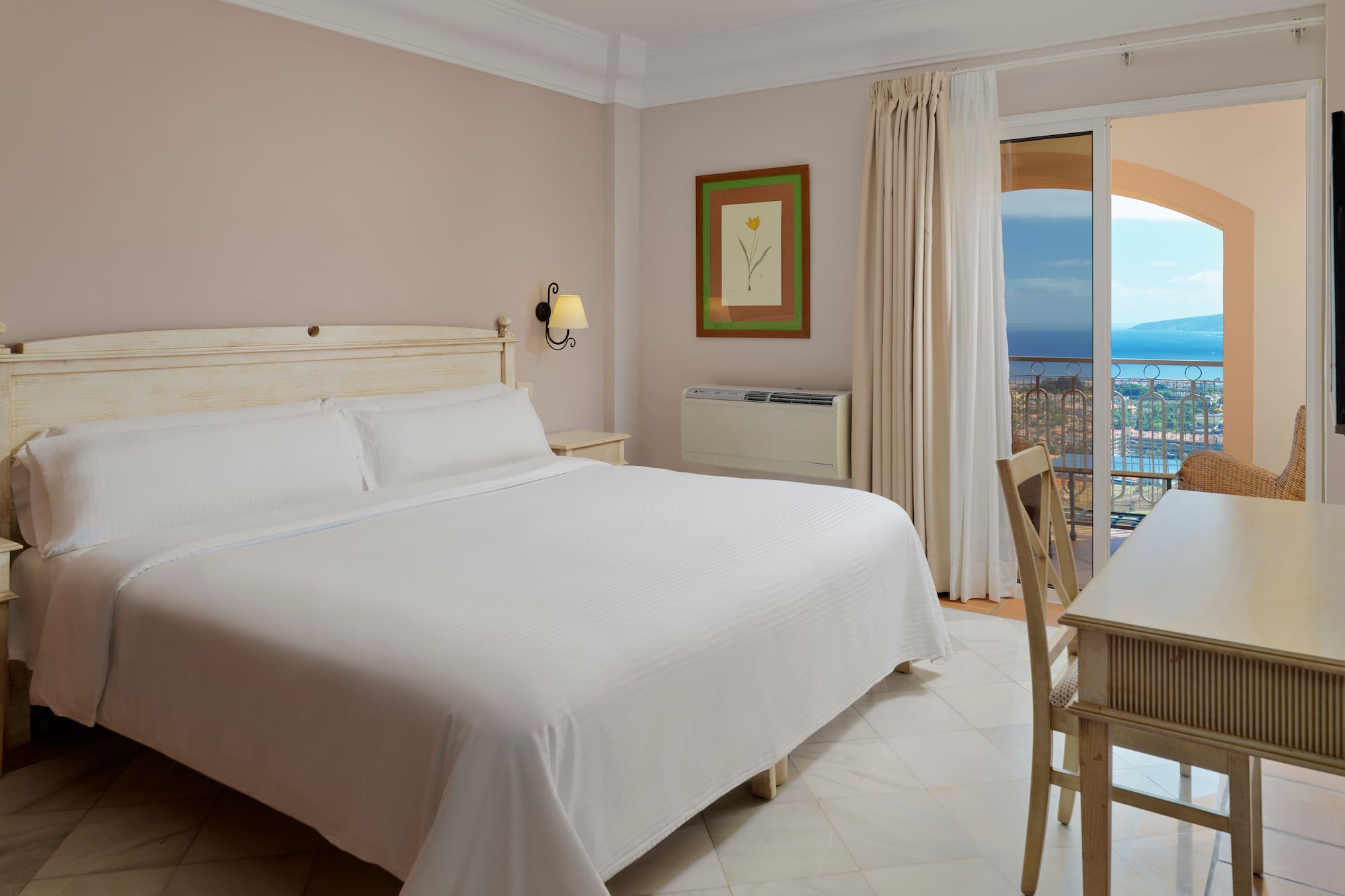 a bedroom with a bed and a table and chairs